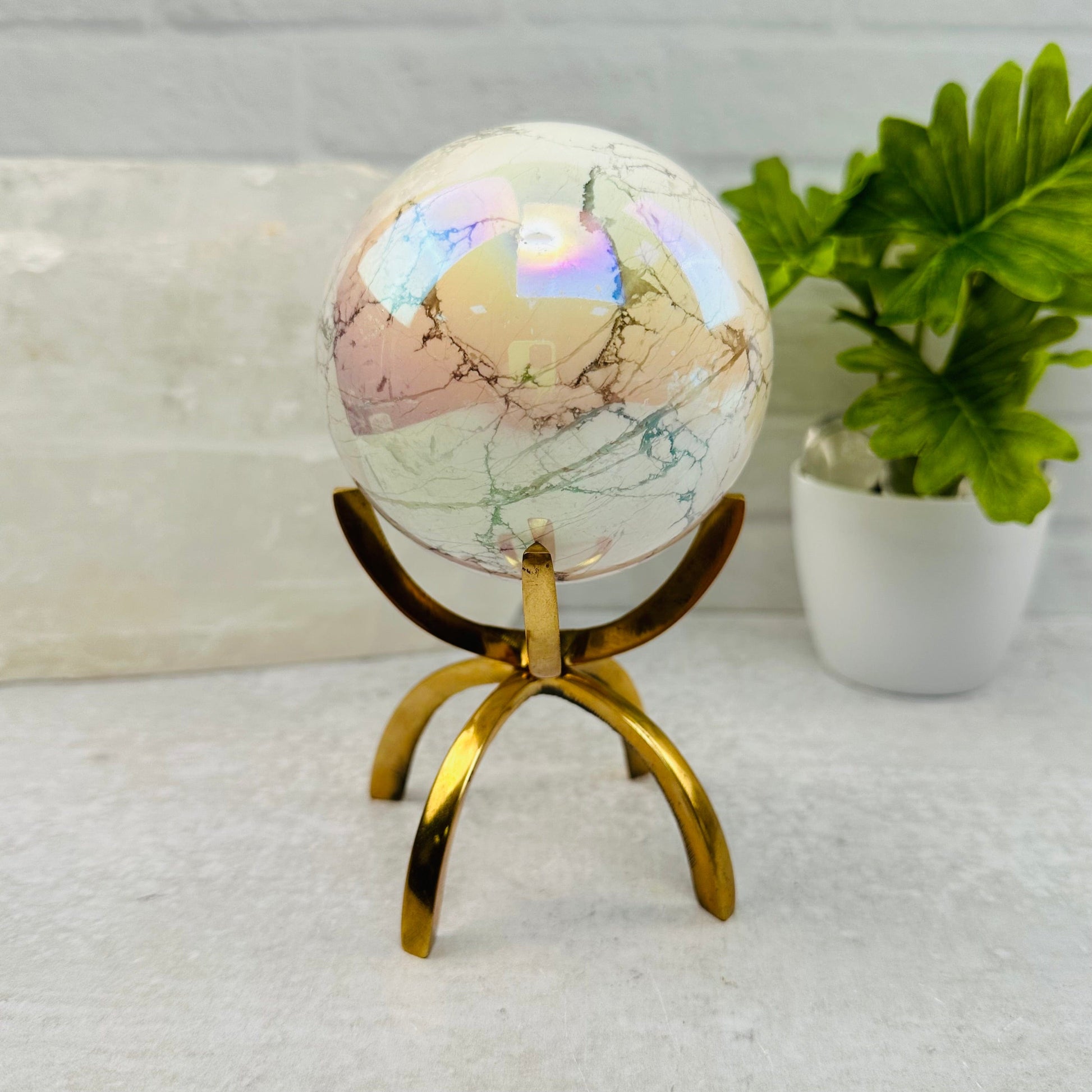 White Howlite Angel Aura Polished Sphere displayed as home decor 