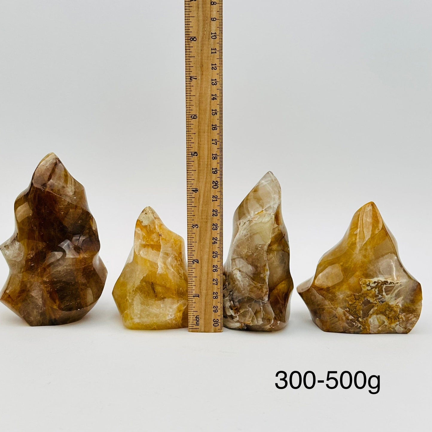golden healer flame points sold by weight. displayed next to a ruler for size reference 