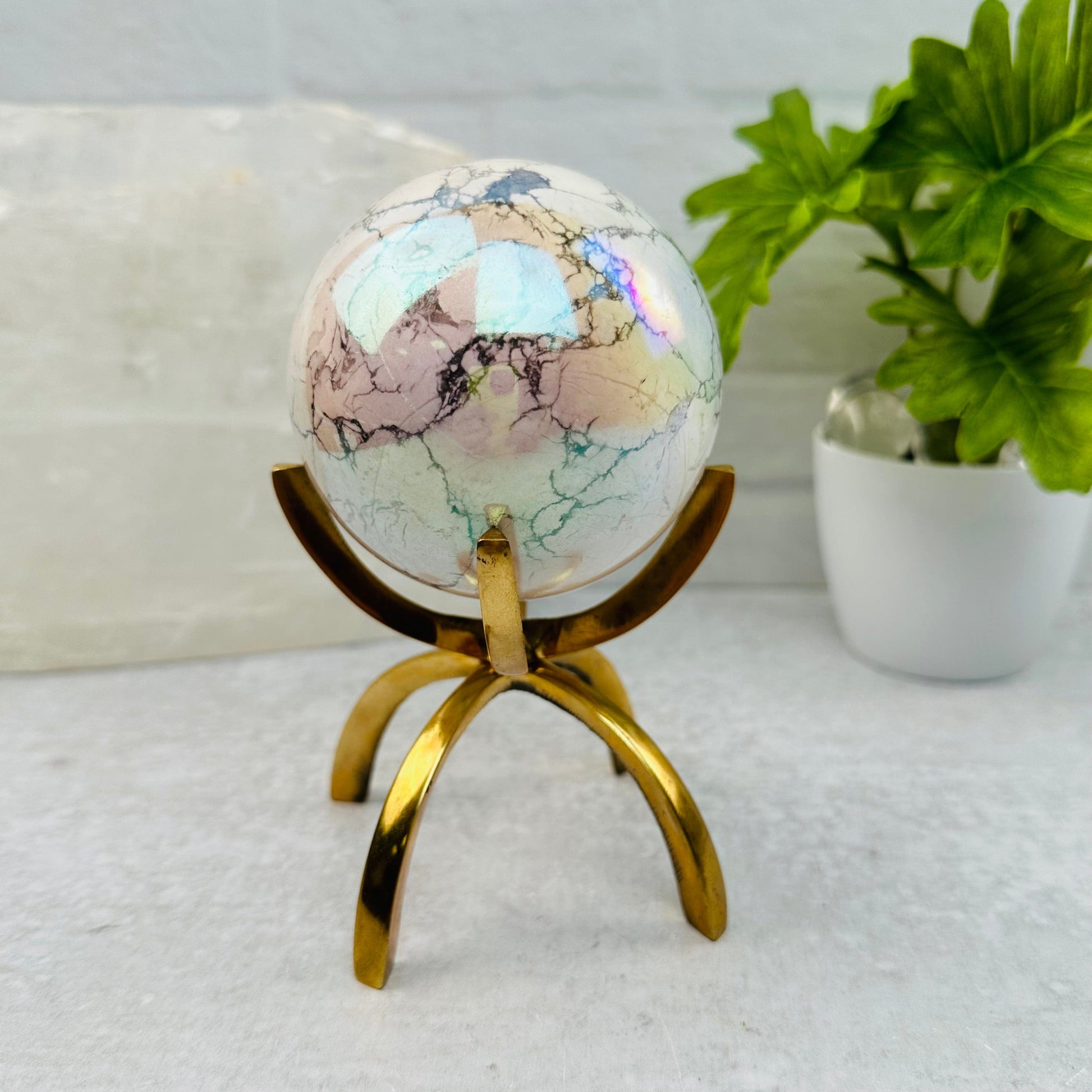 White Howlite Angel Aura Polished Sphere displayed as home decor 
