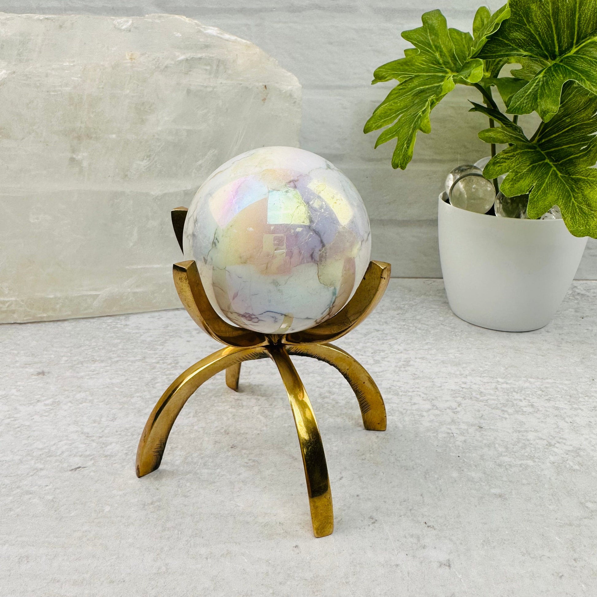 White Howlite Angel Aura Polished Sphere displayed as home decor 