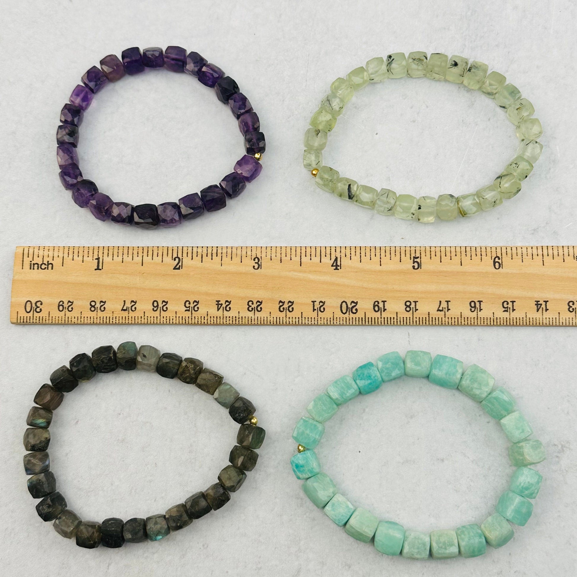 bracelets next to a ruler for size reference 