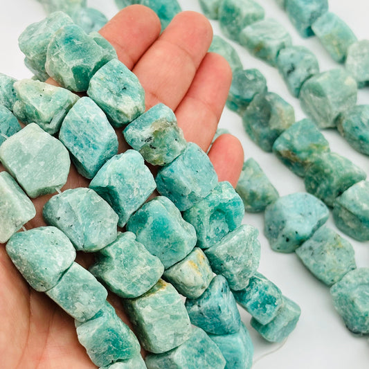 amazonite rough stone beads in hand for size reference 