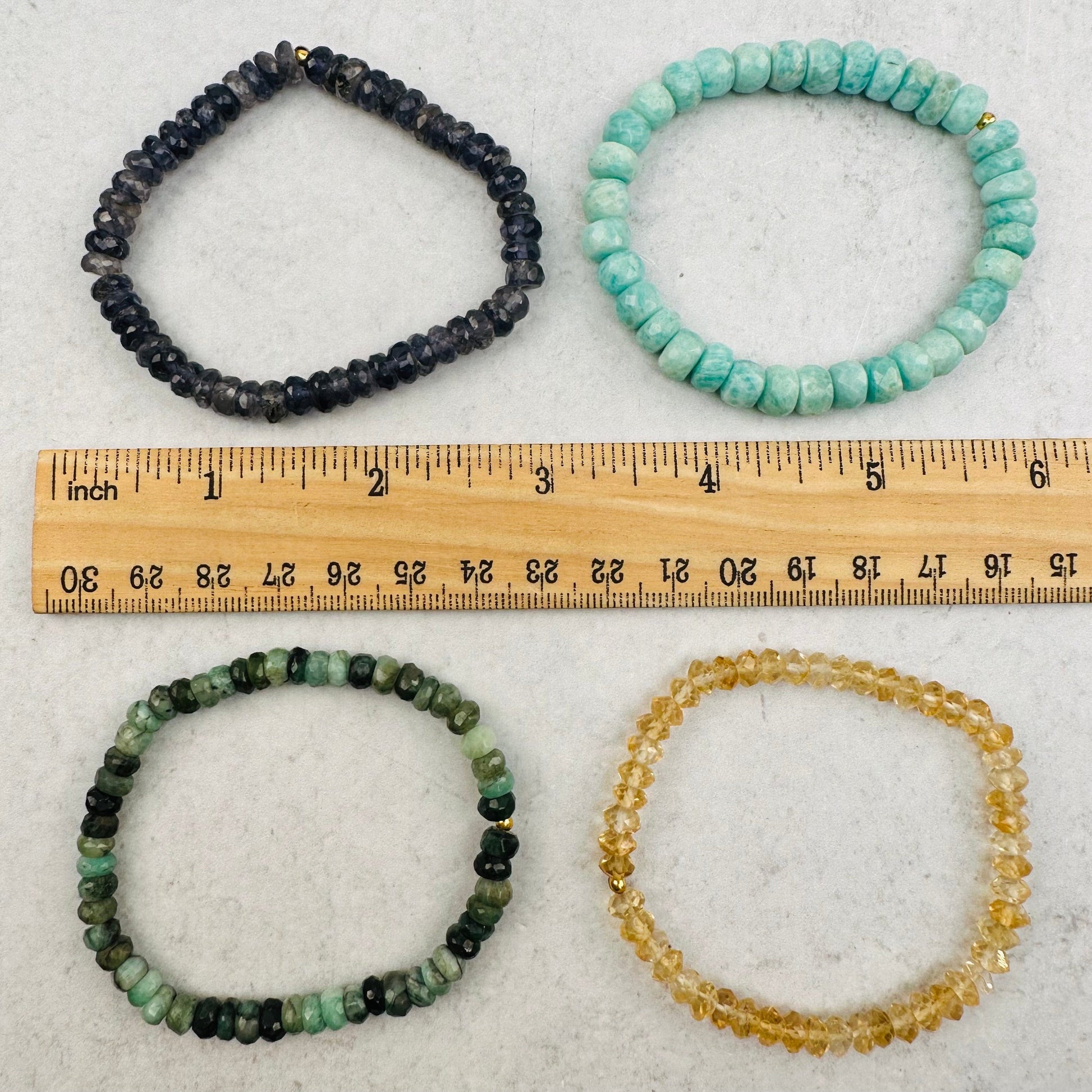 bracelets next to a ruler for size reference 