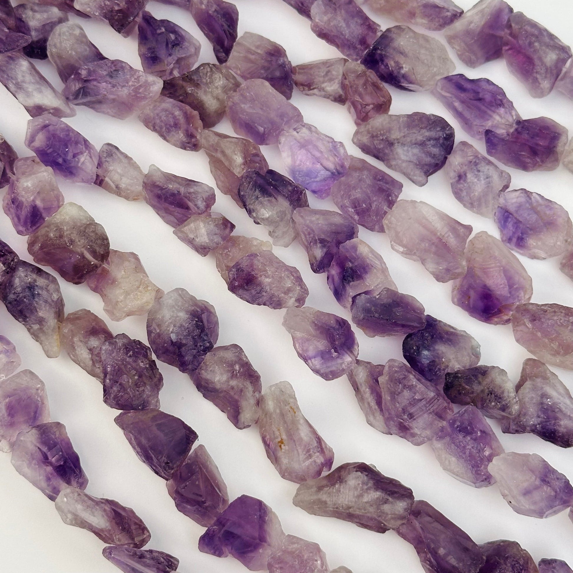 multiple crystal bead strands displayed to show the differences in the sizes and color shades 