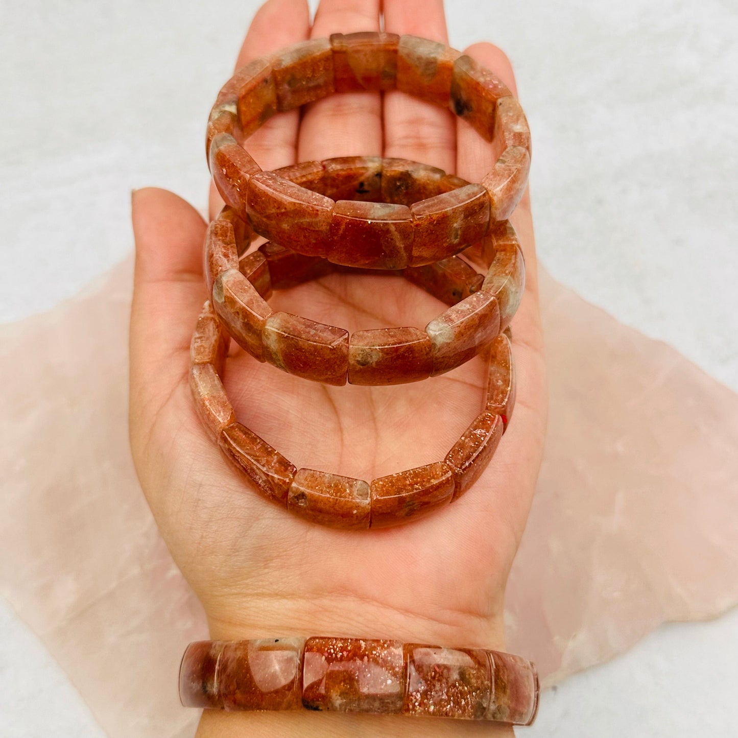 Golden Sunstone Bracelets in hand for size reference