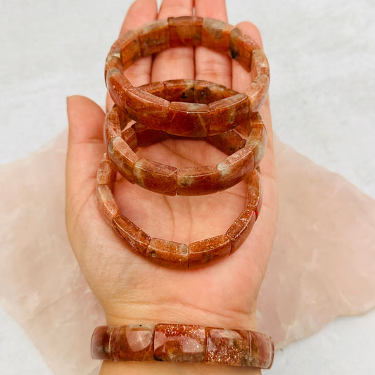 Golden Sunstone Bracelets in hand for size reference