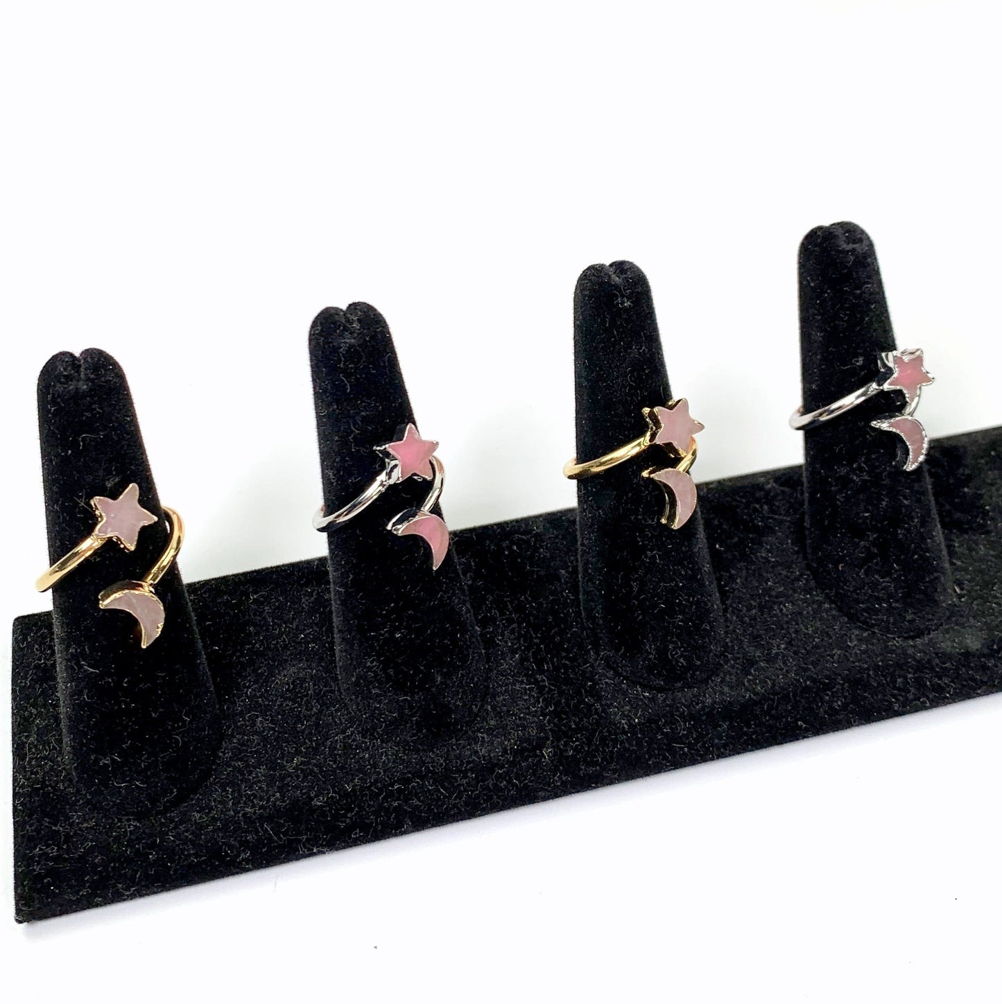 4 rings on black ring holders with white background