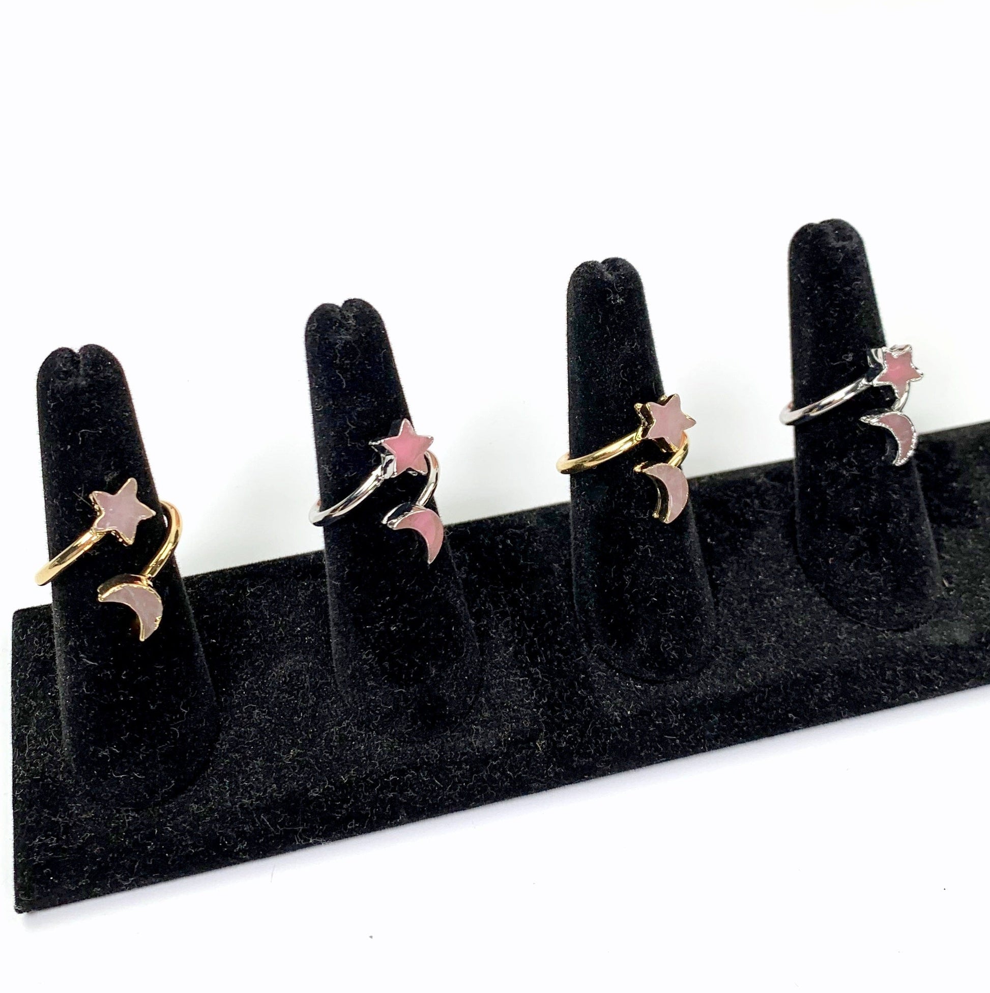 4 rings on black ring holders with white background