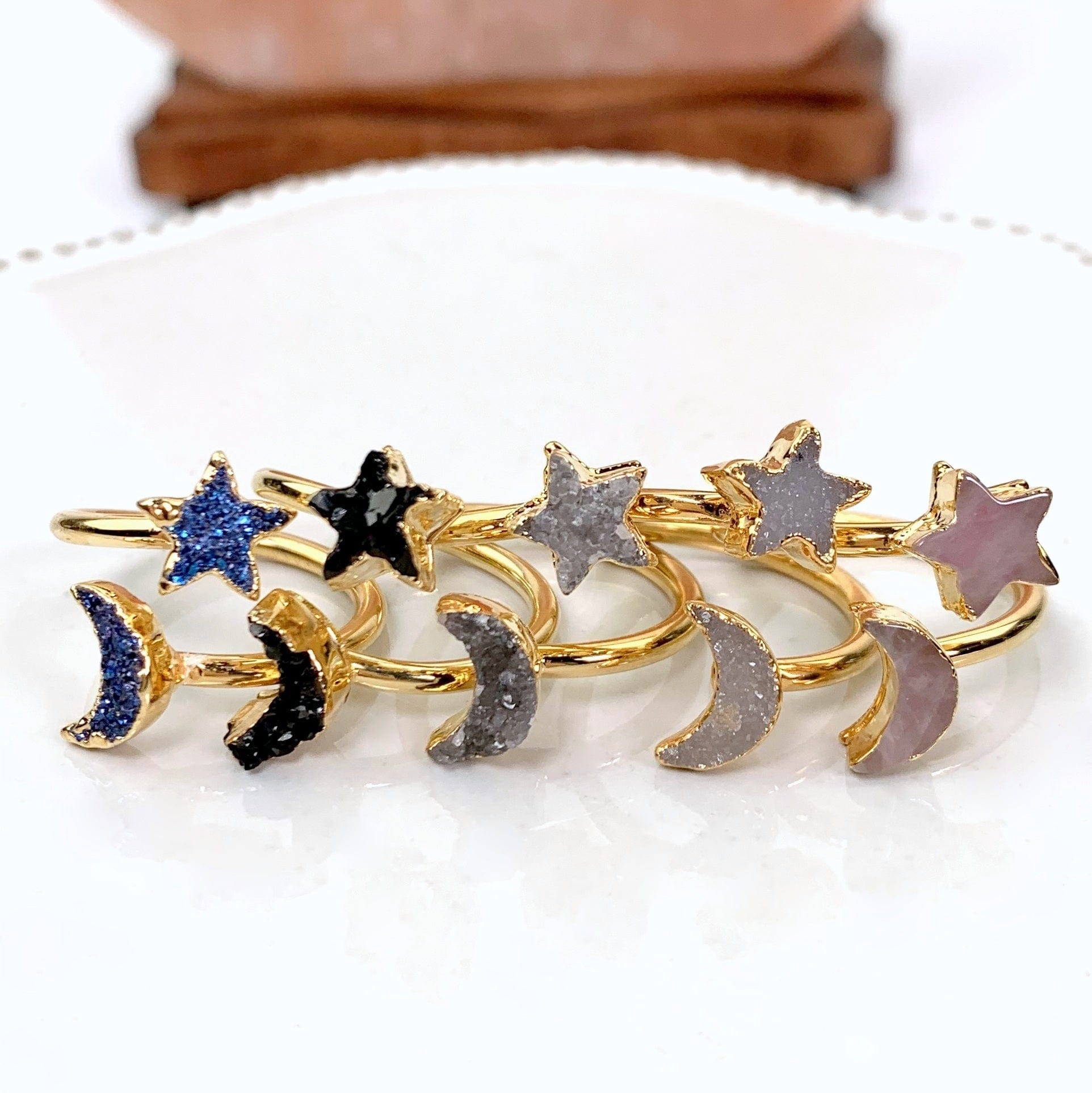 5 gold versions of rings laid out on white