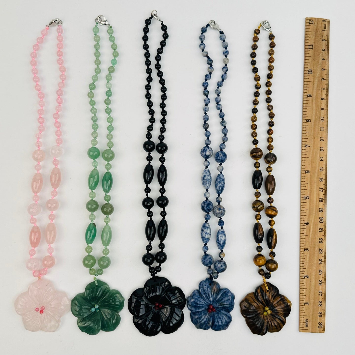necklaces next to a ruler for size reference 
