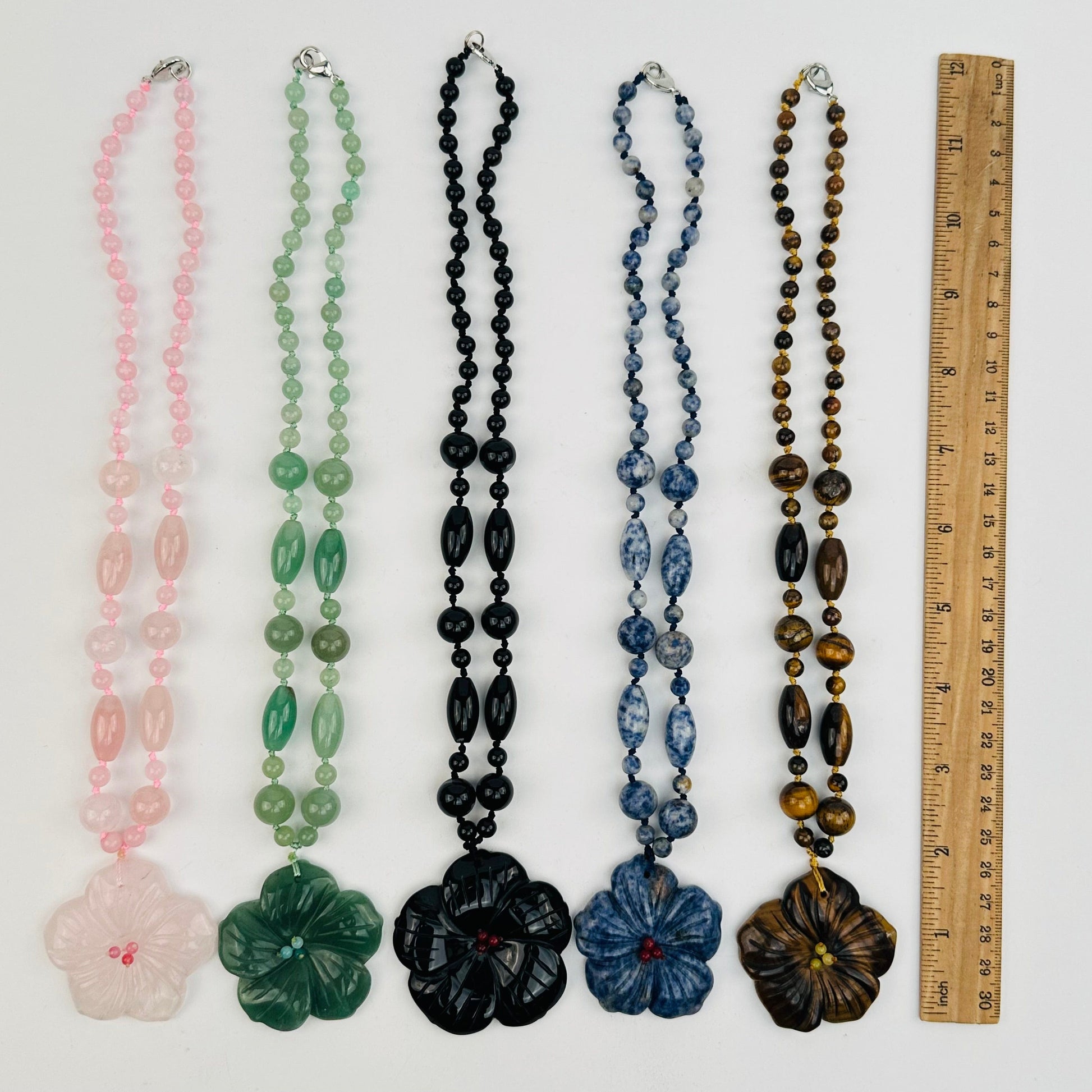 necklaces next to a ruler for size reference 