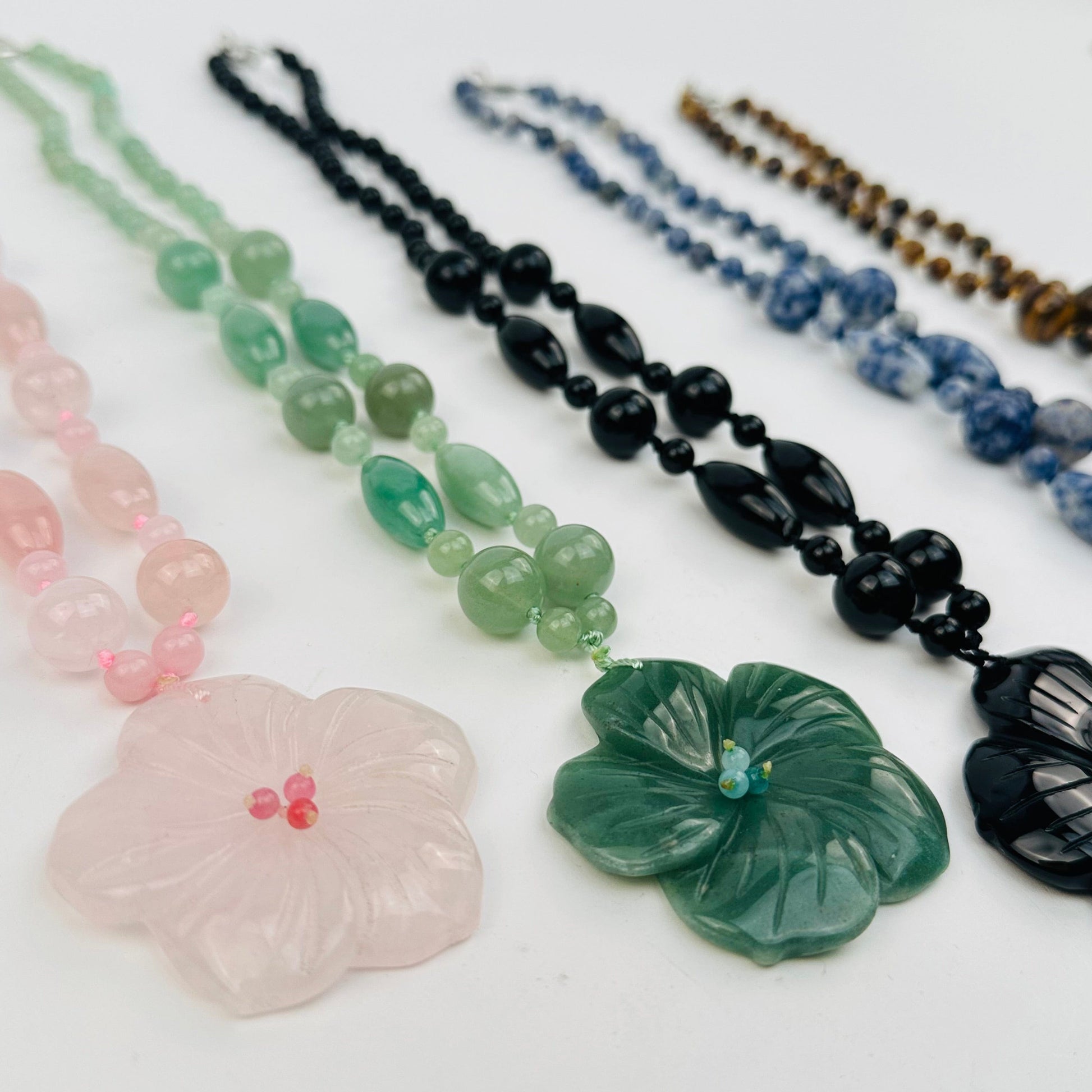 close up of the details on the gemstone necklaces 