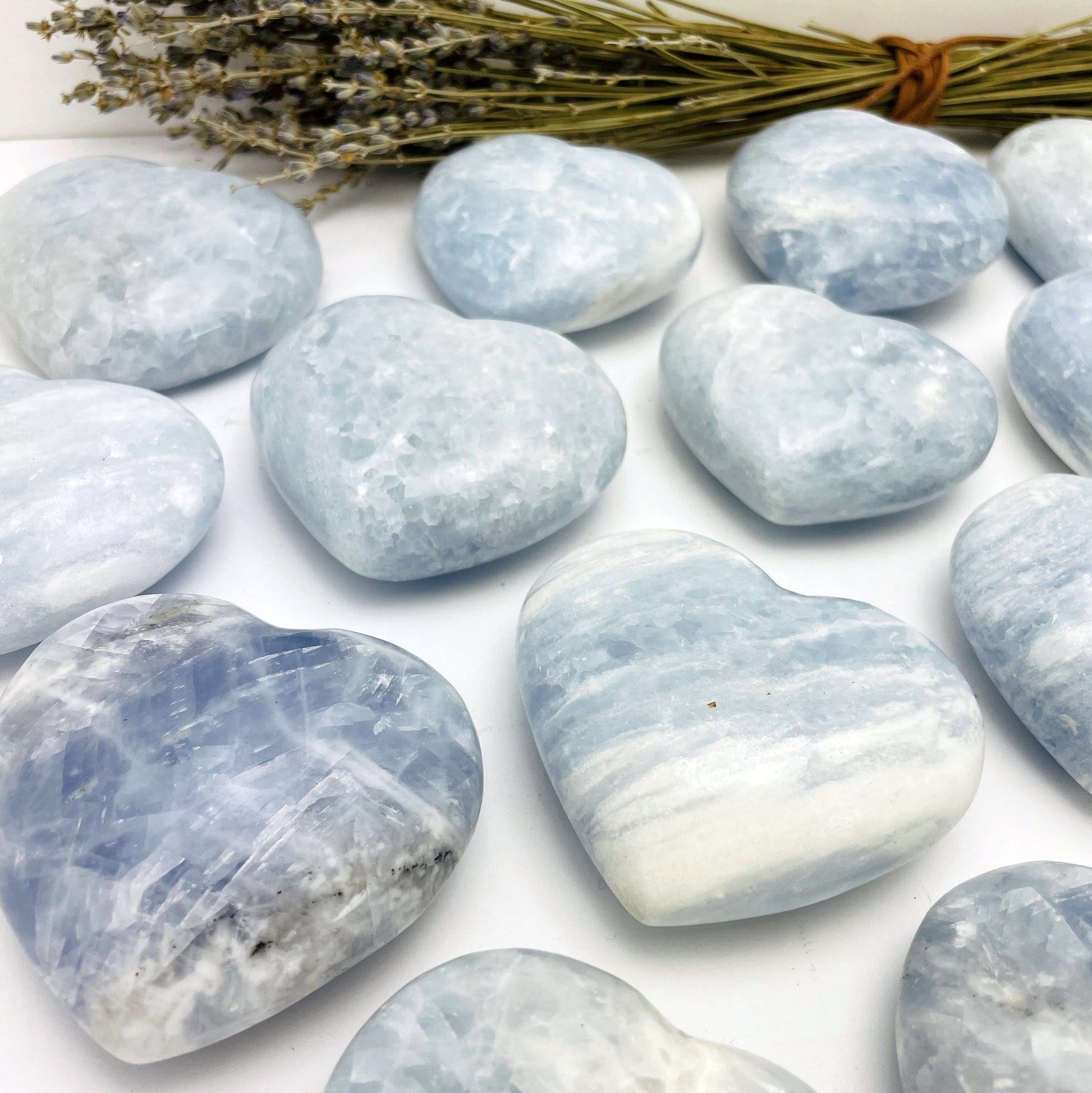 Blue Calcite Hearts on a table from a side view showing thickness