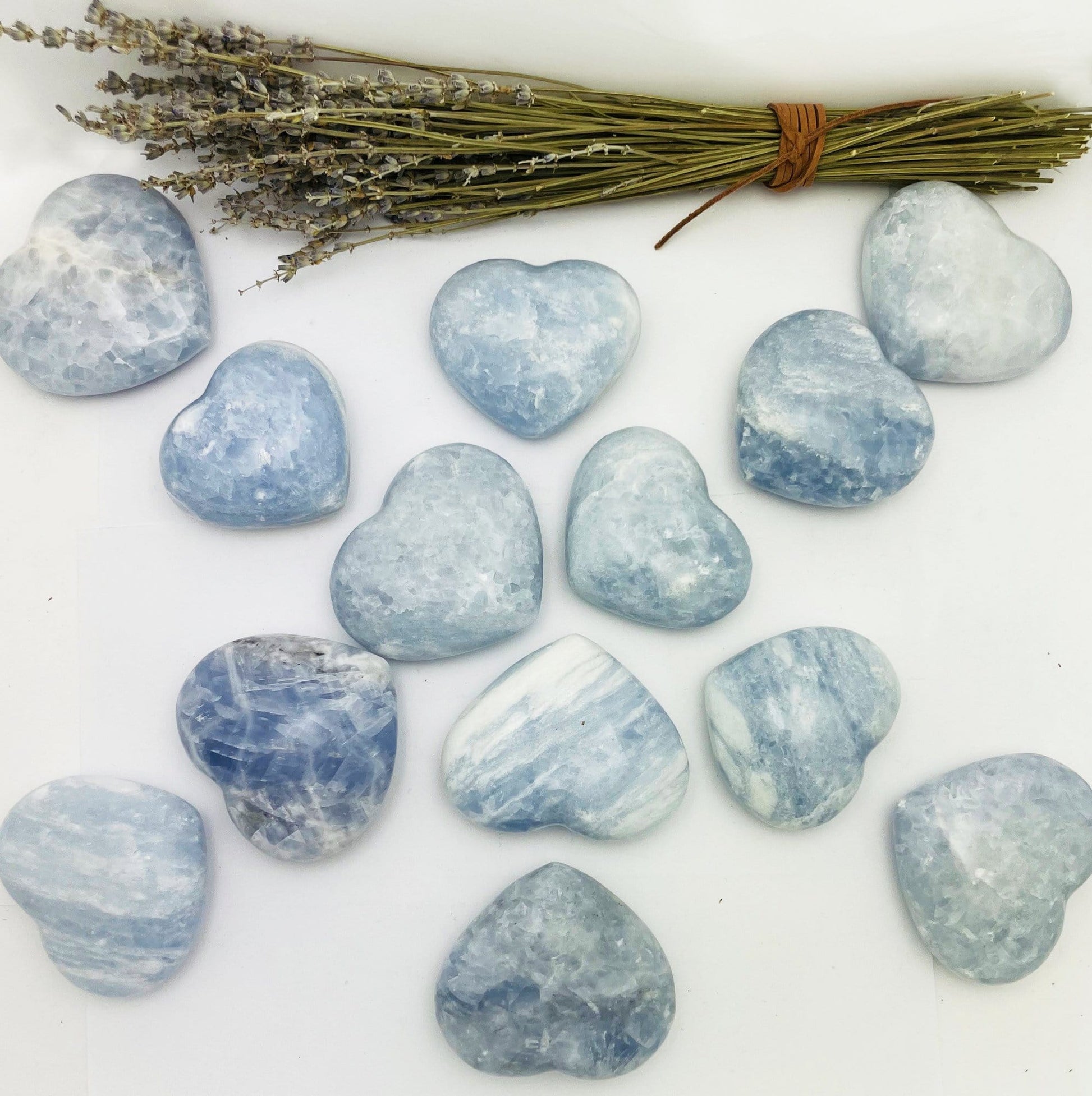 Blue Calcite Hearts on display on a table with flowers