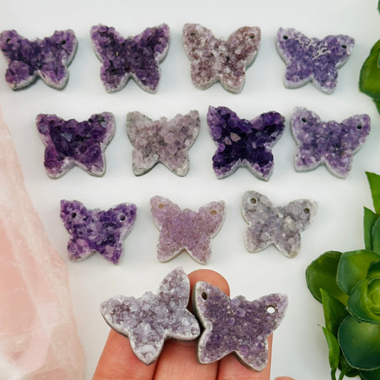 multiple amethyst crystal cabochons displayed to show the differences in the sizes and color shades 