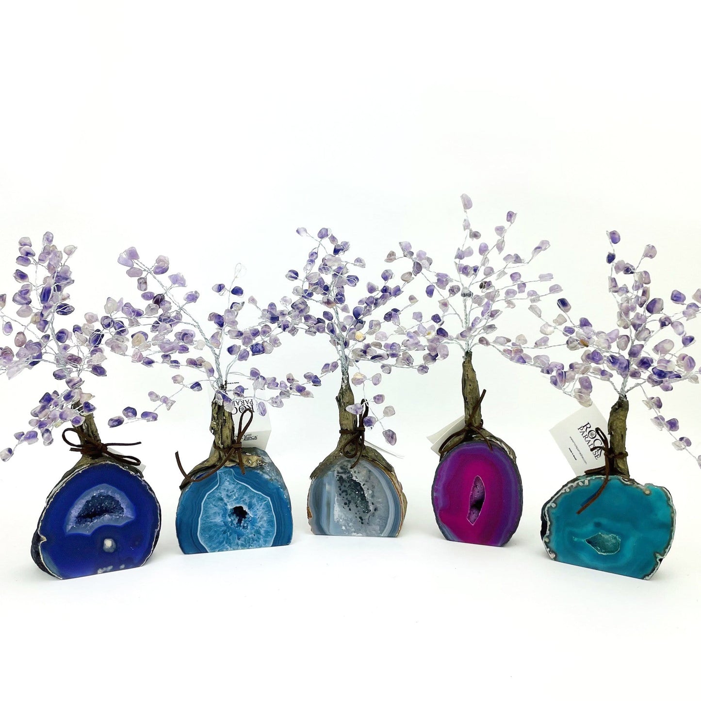 amethyst trees with dyed geode bases displayed to show the differences in the color types 