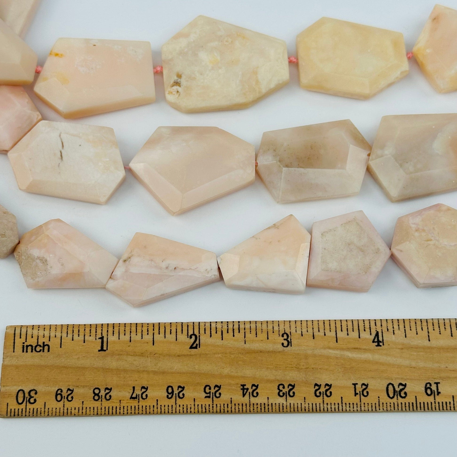 beads next to a ruler for size reference 
