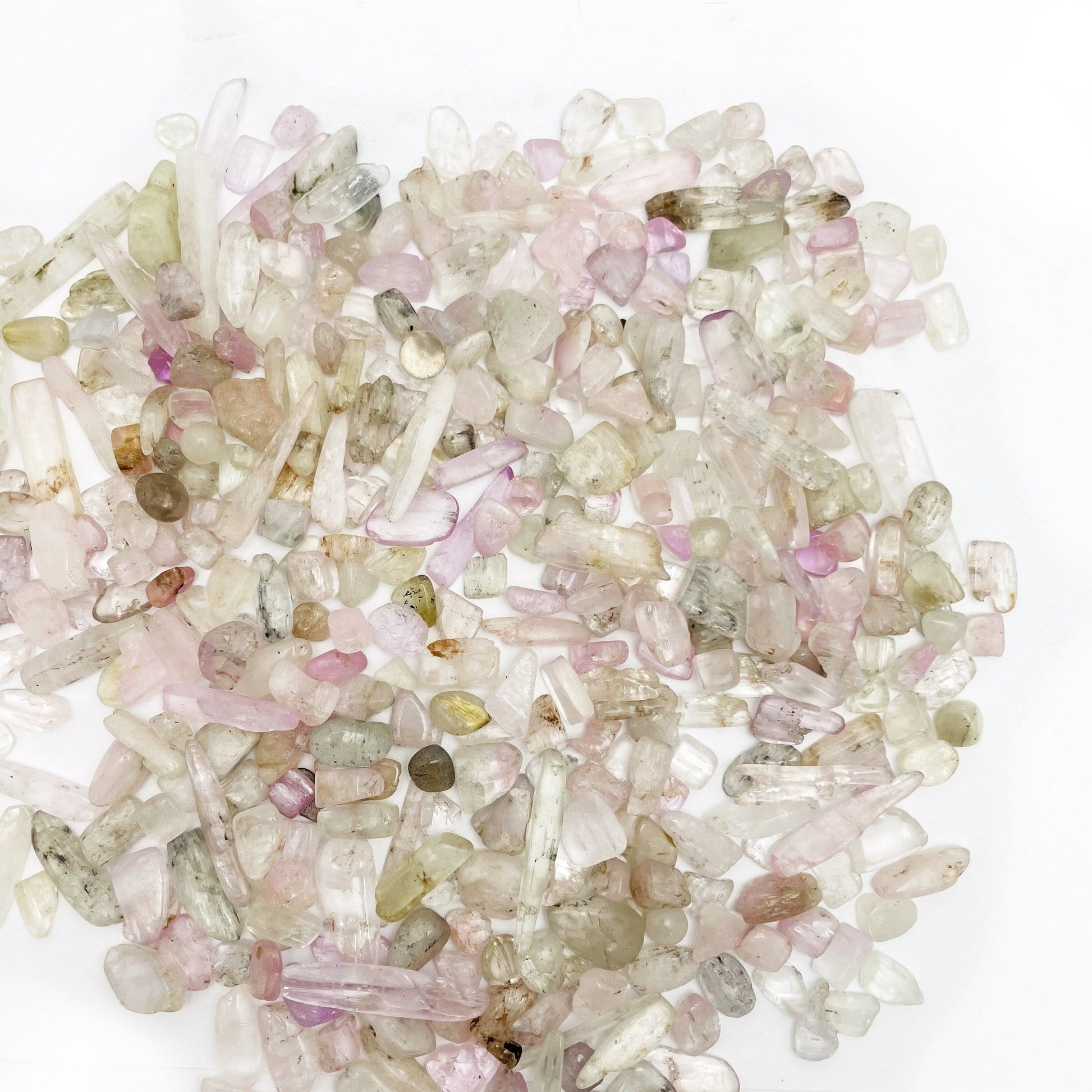 Kunzite 1lb Chips scattered on a table