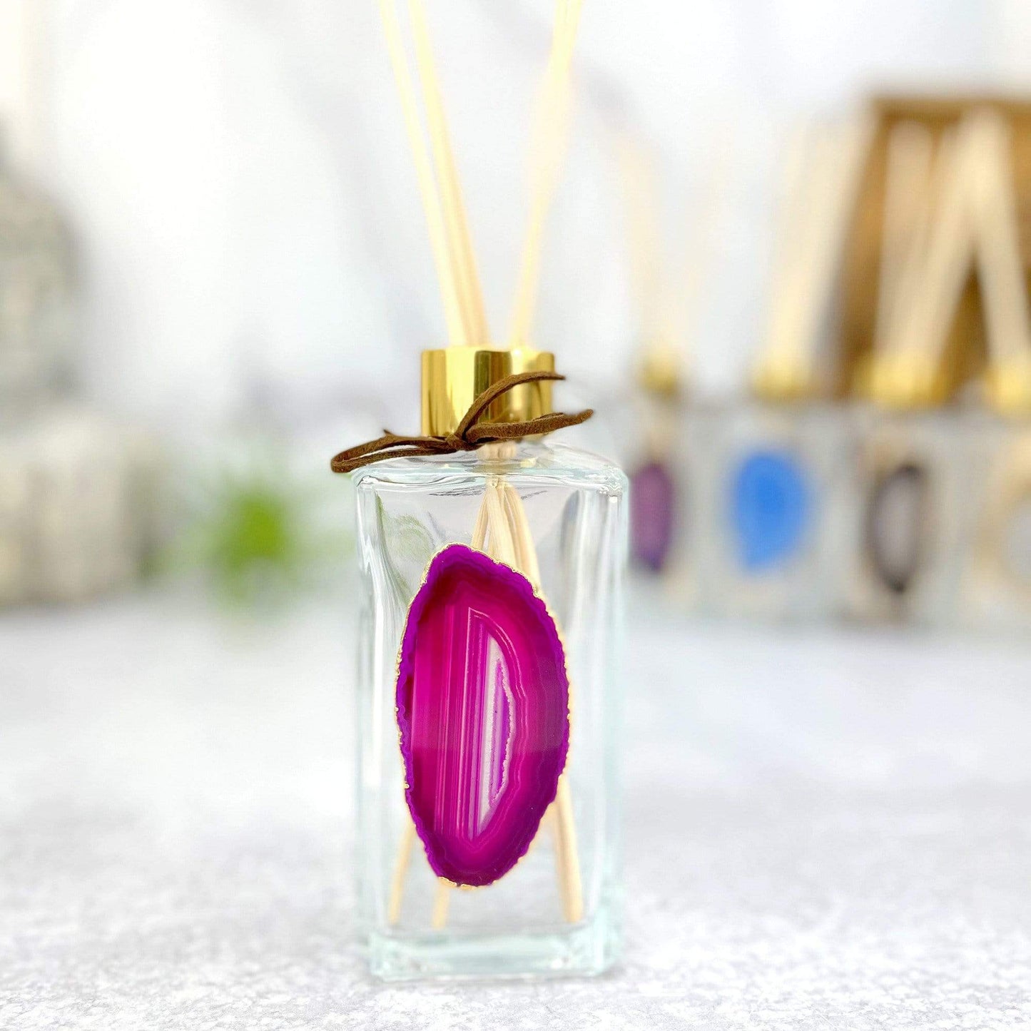 Picture of our pink agate slice diffuser, being displayed on a white back ground.