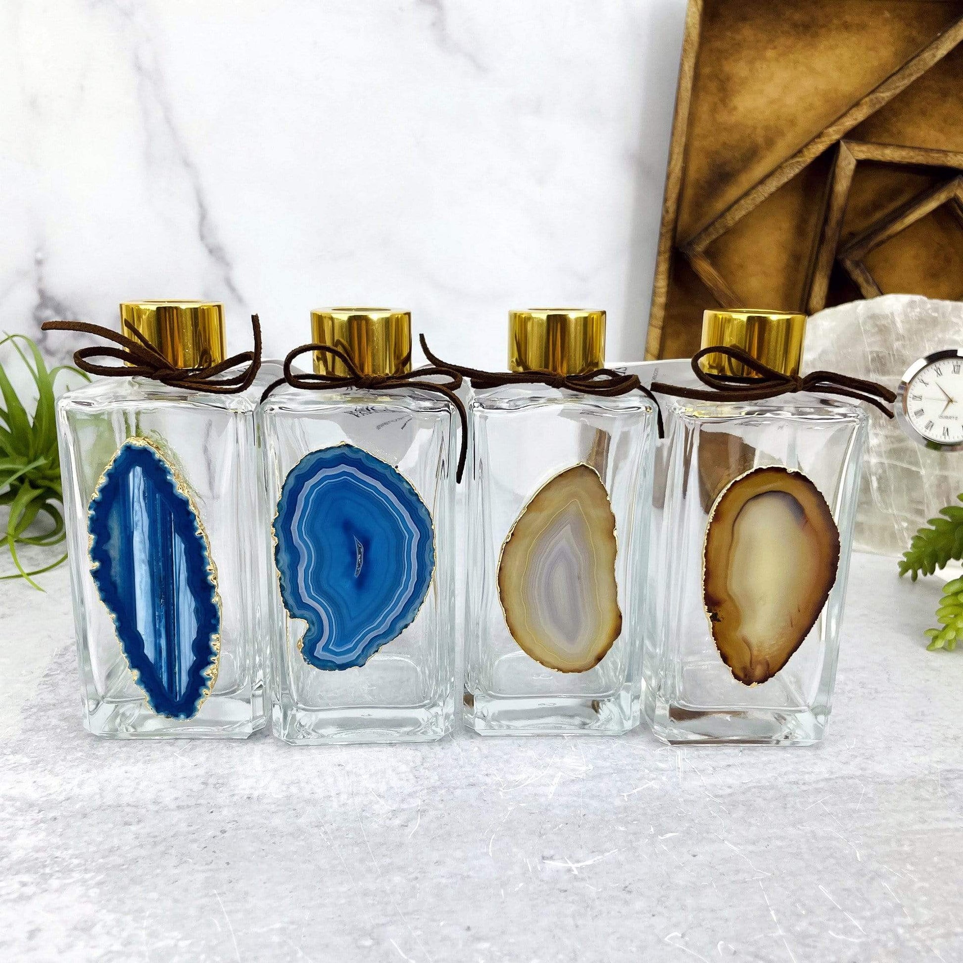 Picture of two of our blue and two of our natural diffusers being displayed next to each other.
