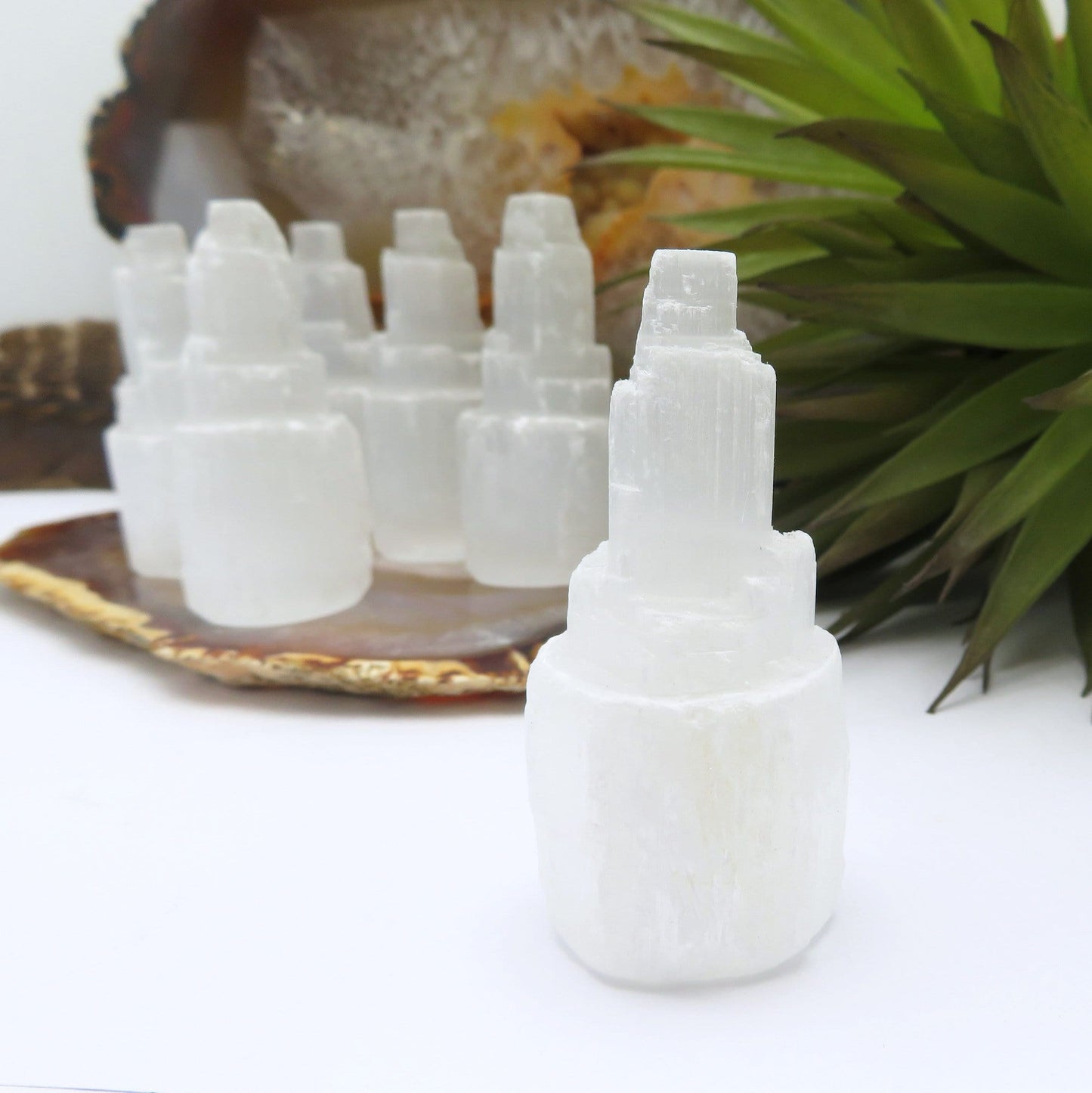 close up of one selenite raw crystal tower for details with others in background display