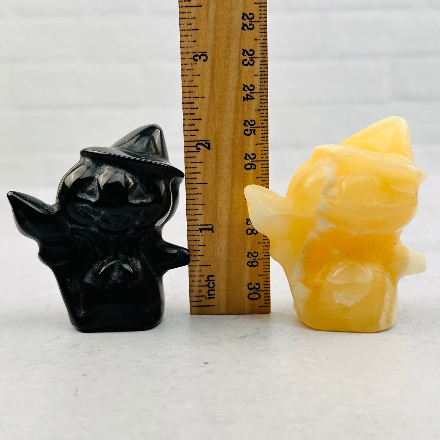 gemstones next to a ruler for size reference 