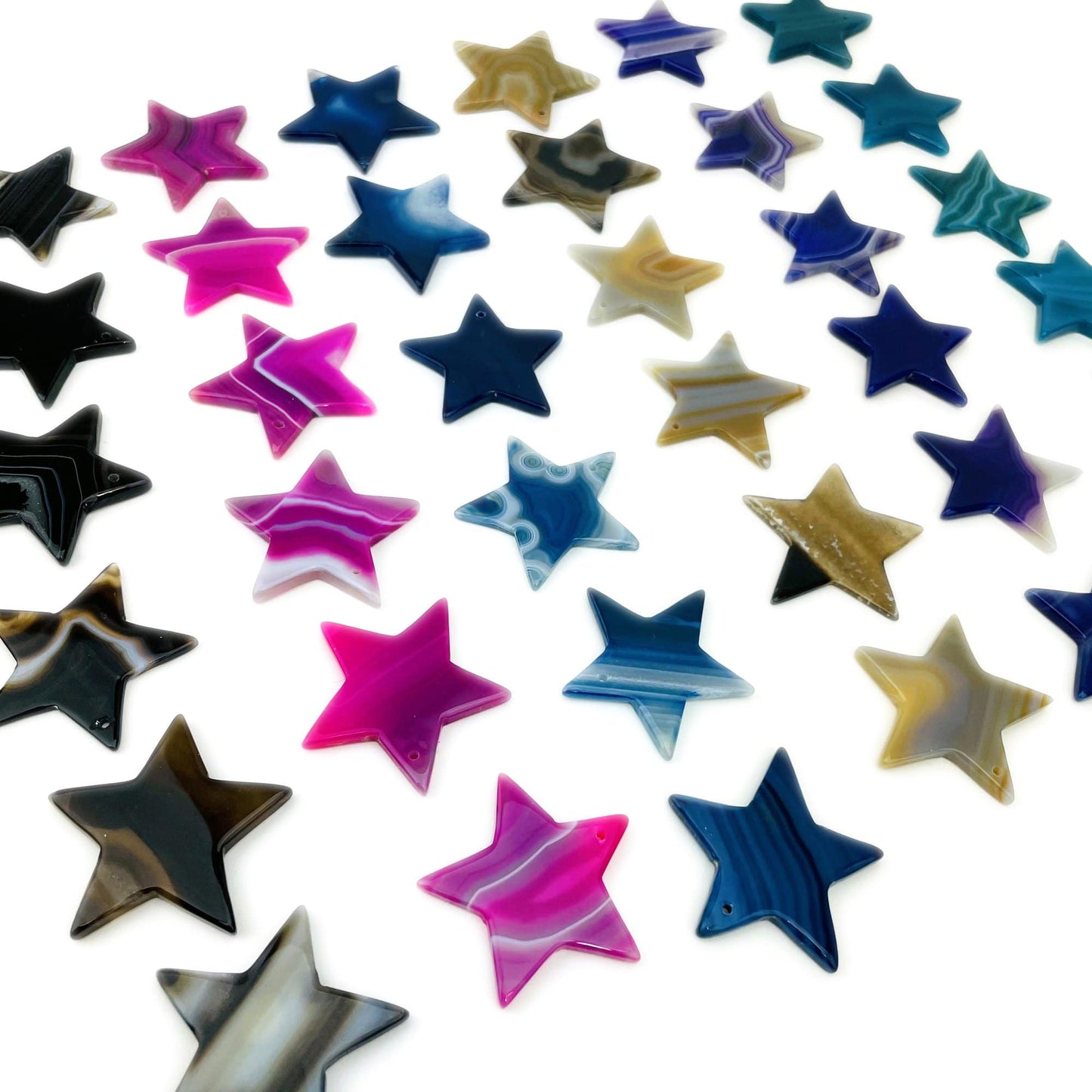 Assorted Drilled Agate Stars Different Color on White Background.