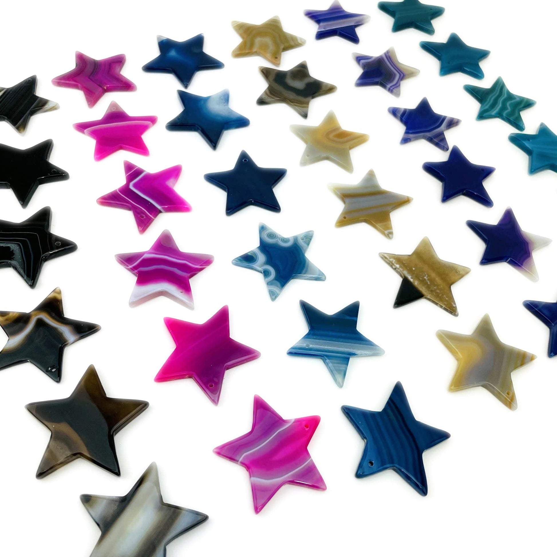 Assorted Drilled Agate Stars Different Color on White Background.