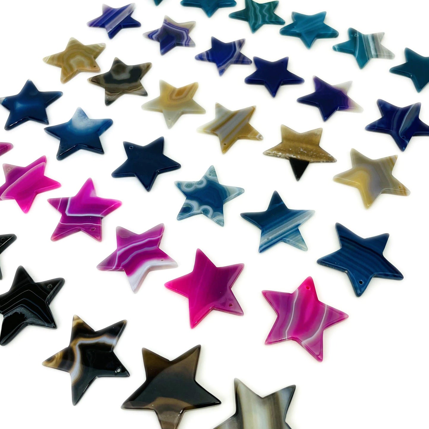 Side Angle Assorted Drilled Agate Stars Different Color on White Background.