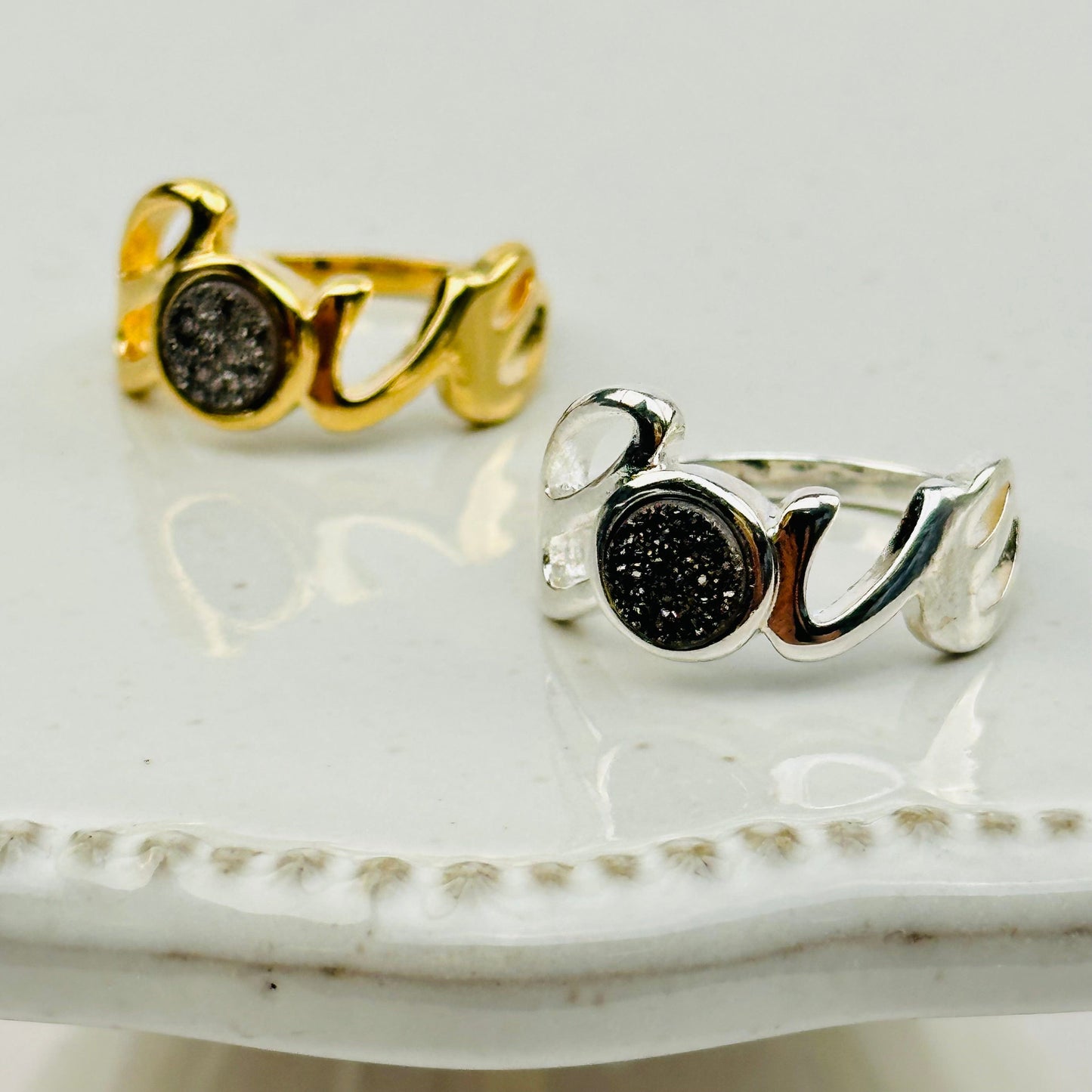 close up of the details on these black titanium druzy rings 