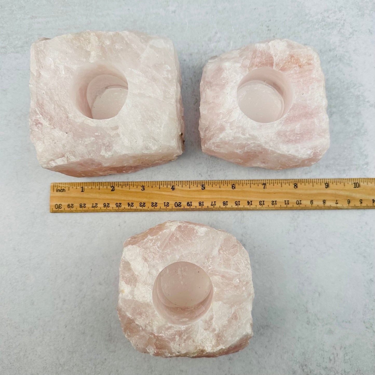 rose quartz candle holders displayed next to a ruler for size reference 