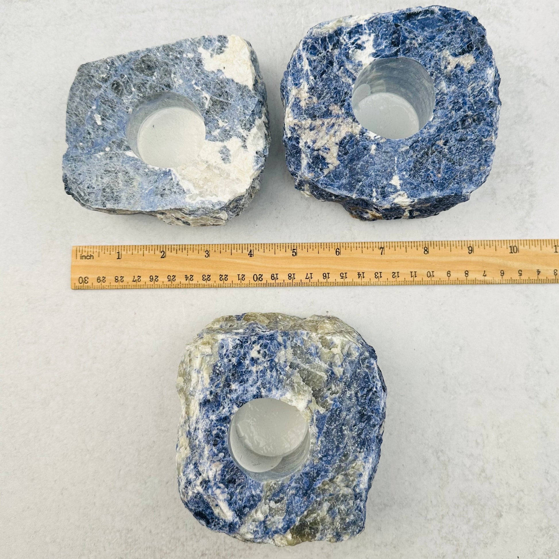 candle holders next to a ruler for size reference 