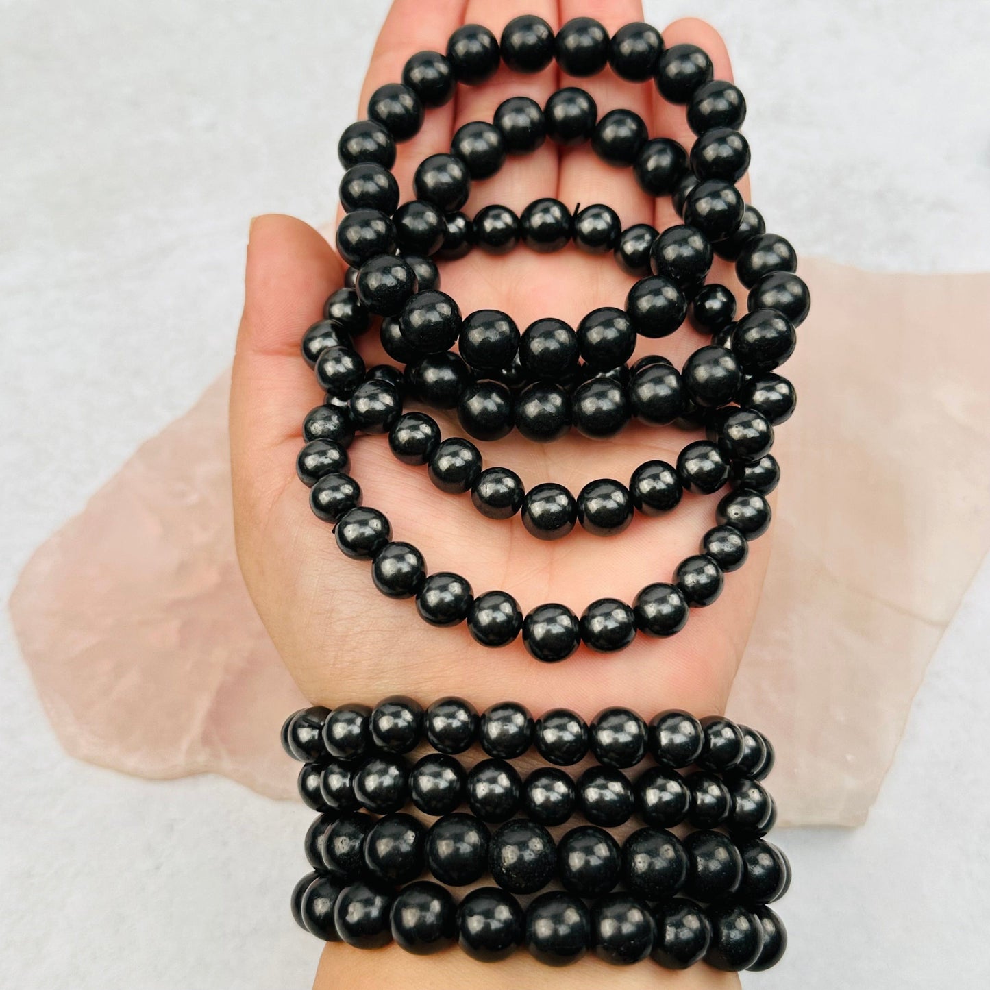 Shungite Bracelets in hand for size reference 