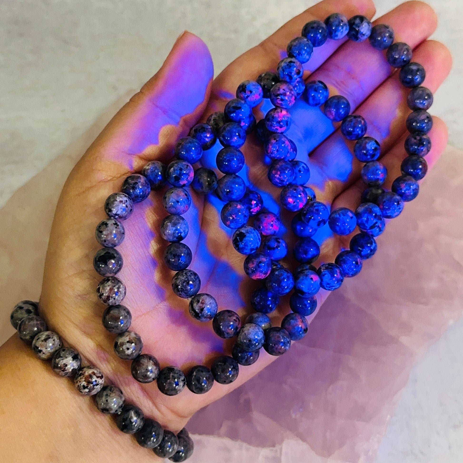 Yooperlite Round Bead Bracelets in hand for size reference 