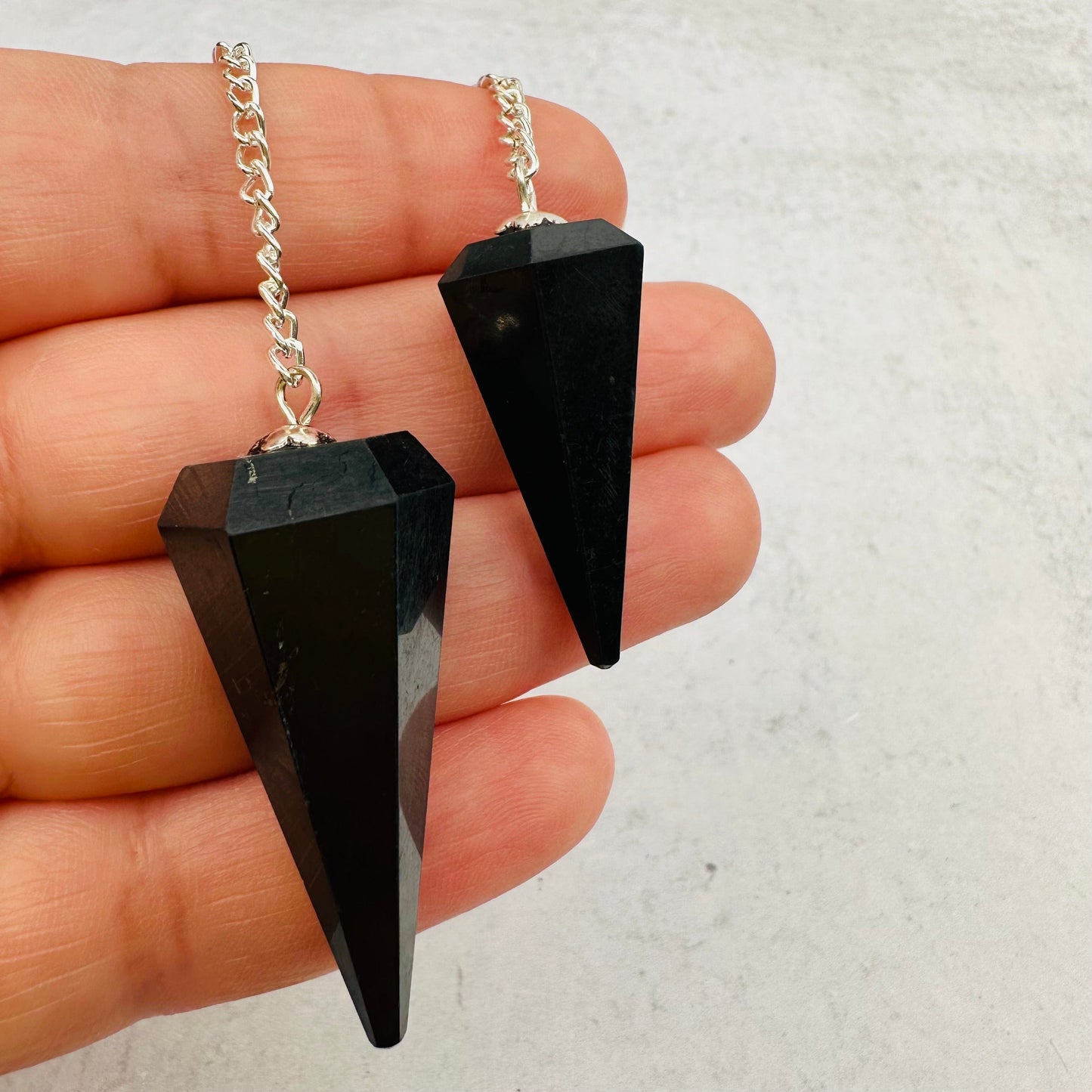 pendulums in hand for size reference 