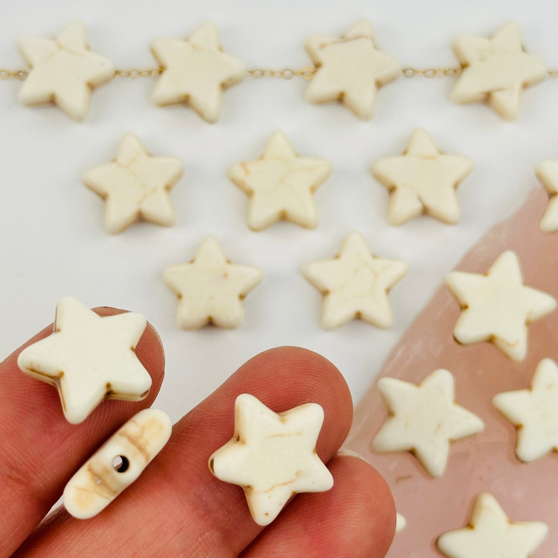 White Turquoise Magnesite Star Beads in hand for size reference 
