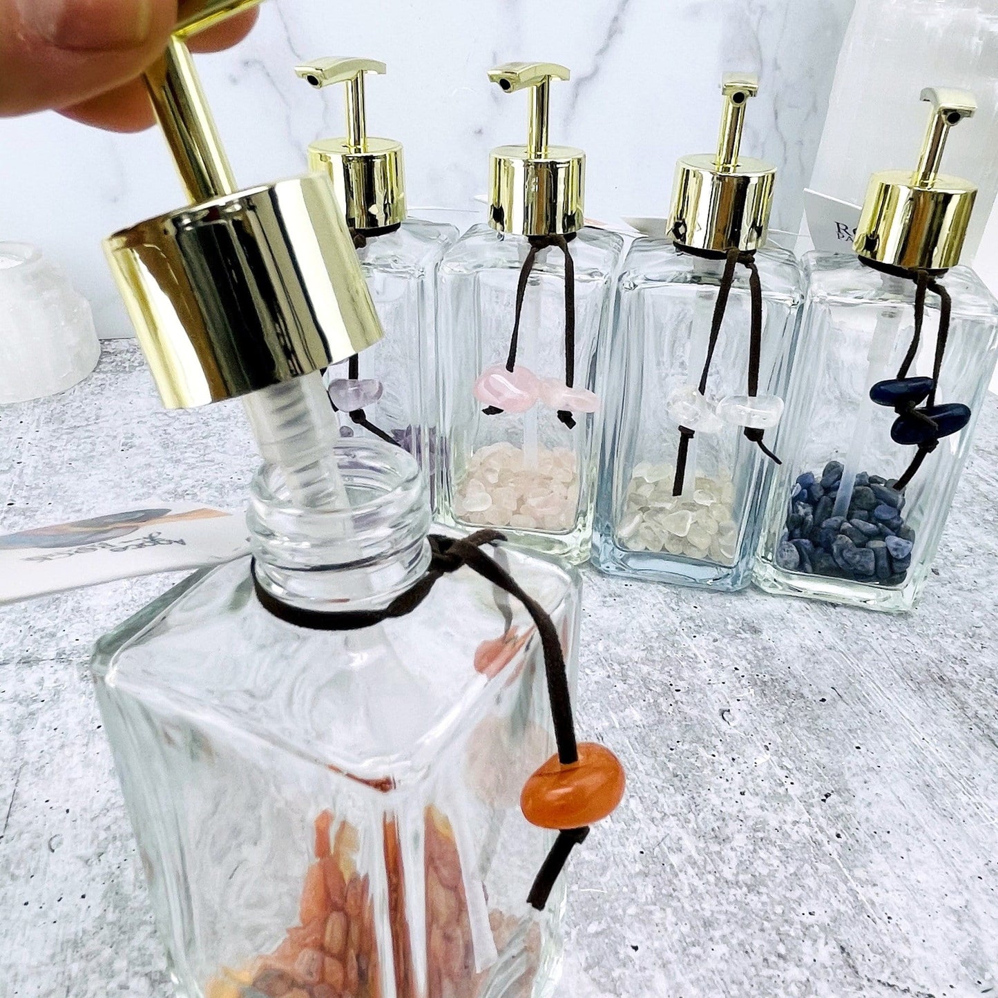 Tumbled Stone Soap Dispensers, one of each stone available showing up close the top opened up