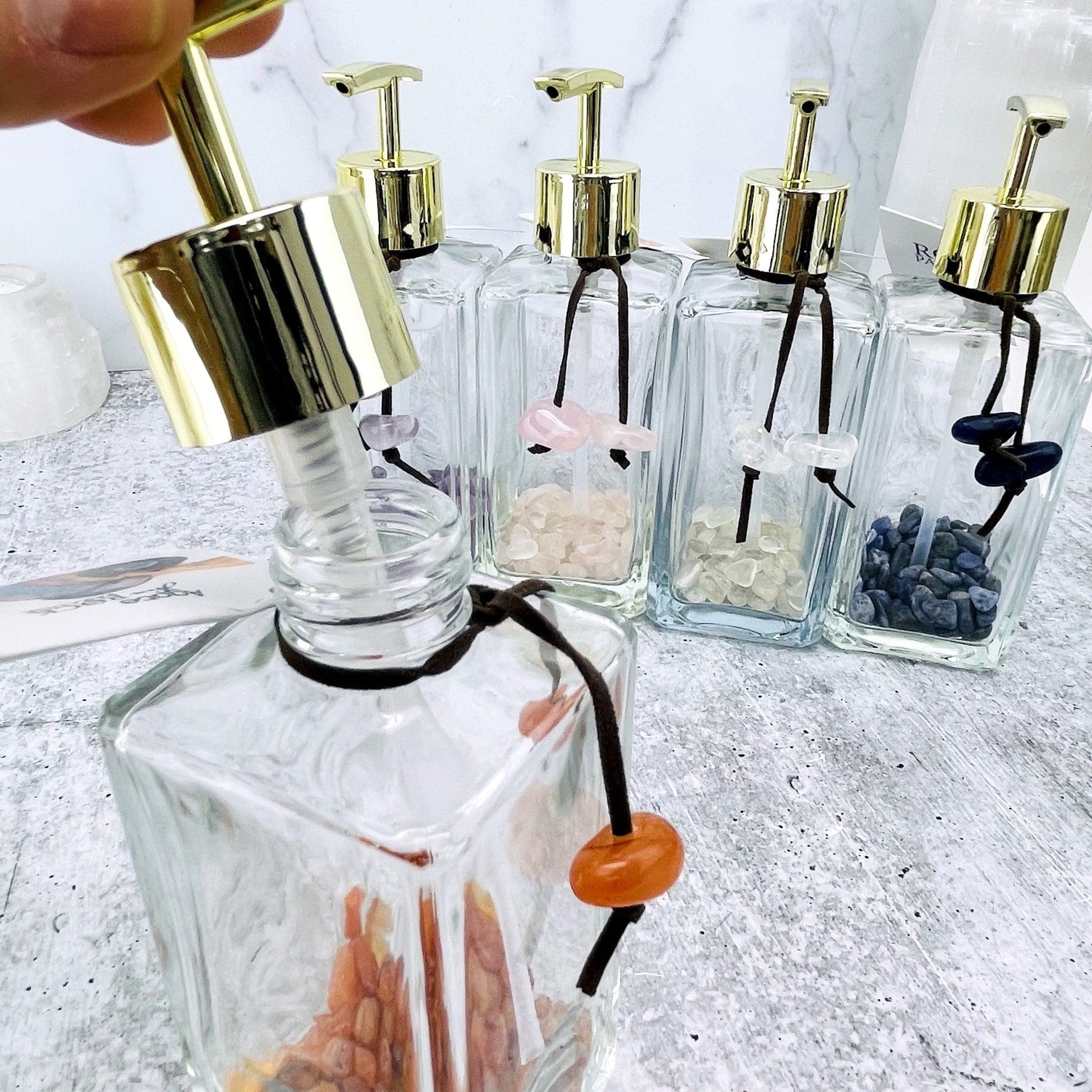 Tumbled Stone Soap Dispensers, one of each stone available showing up close the top opened up