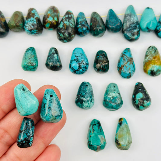Crystal Turquoise Drop Beads in hand for size reference 
