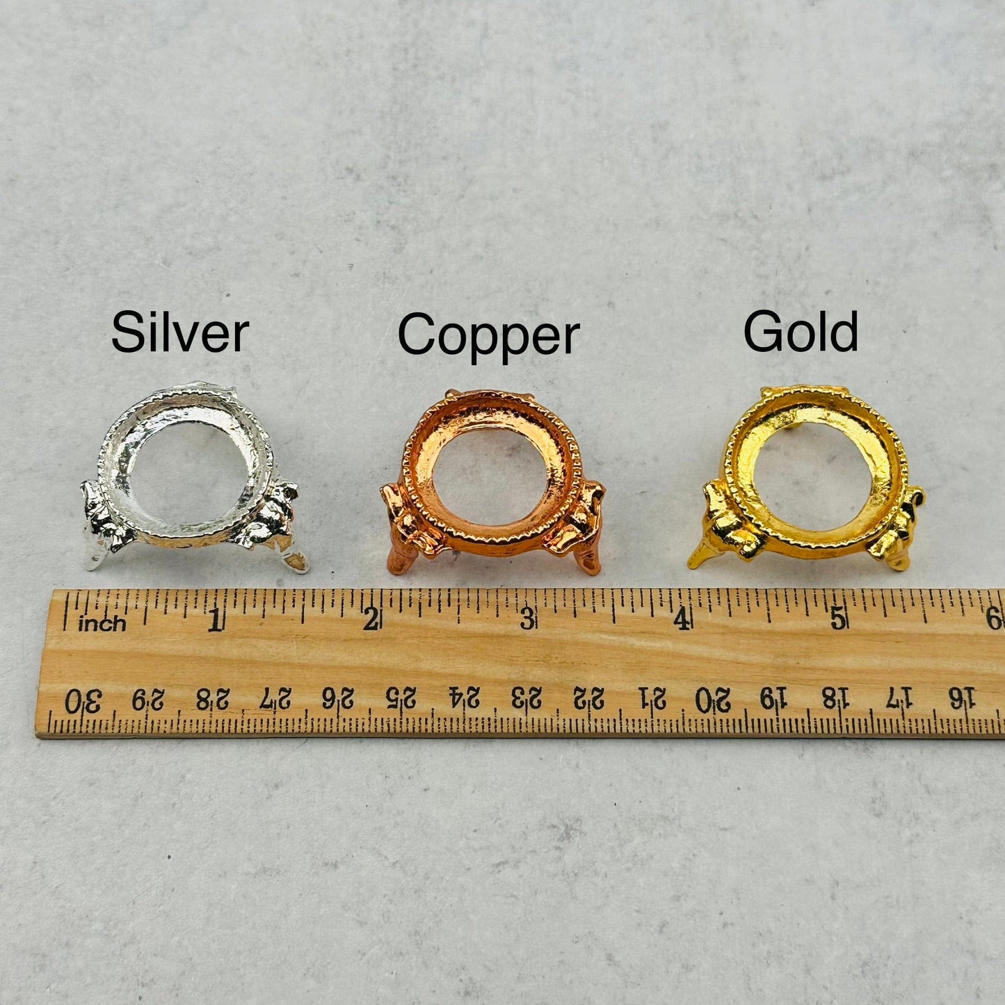 sphere holders next to a ruler for size reference 
