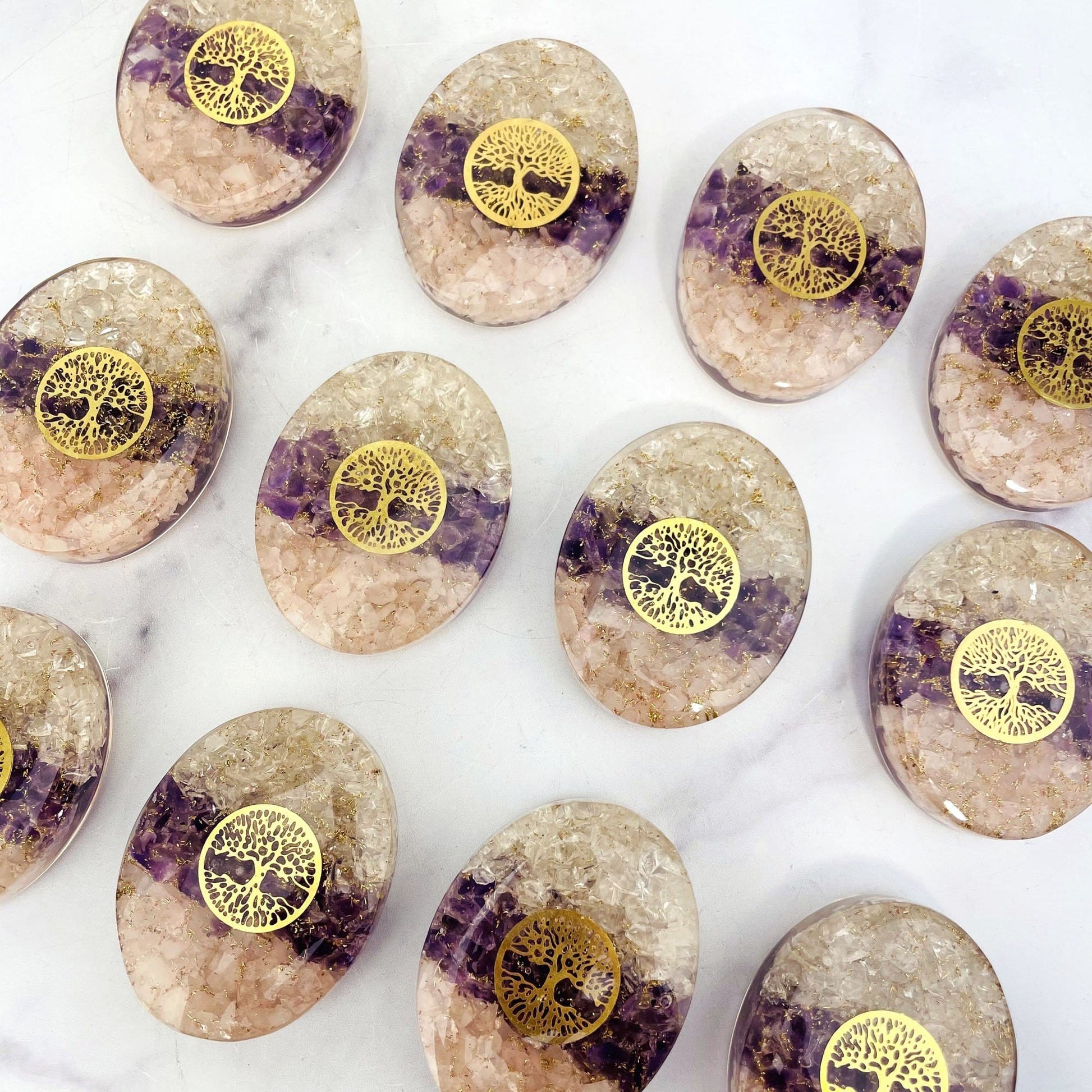 up close of the orgone Energy Palm Stone Amethyst Rose Quartz Crystal Quartz chips and Tree of Life medallion in the center
