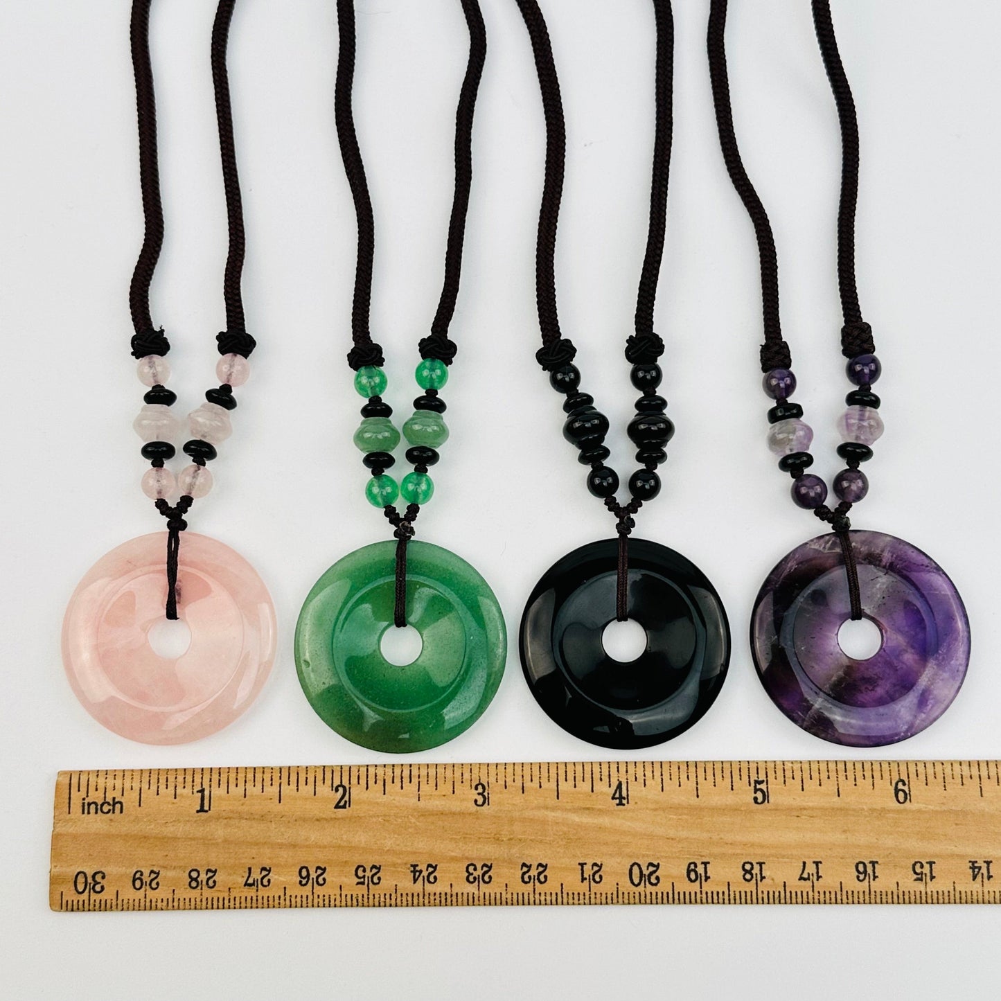 round gemstones displayed next to a ruler for size reference 