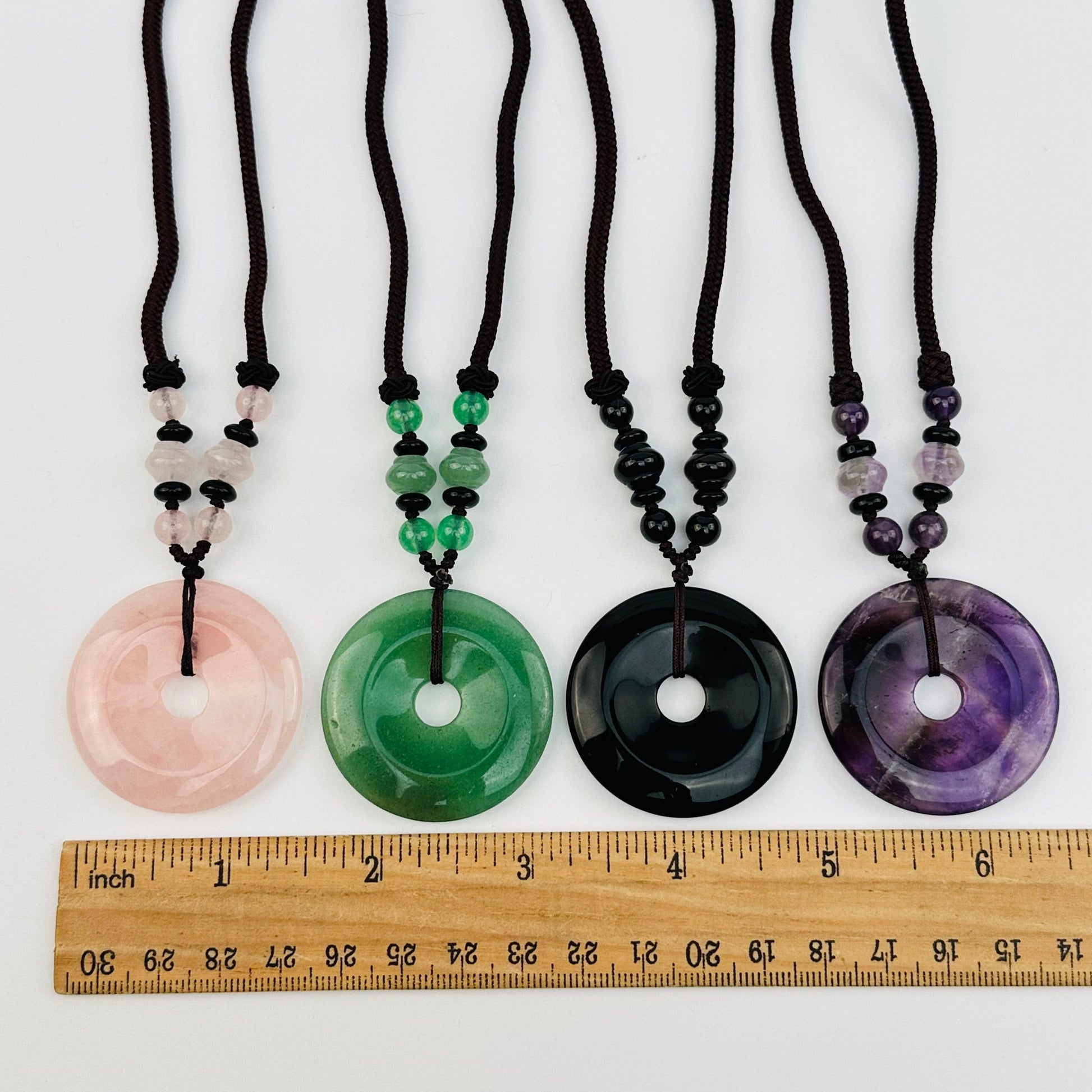 round gemstones displayed next to a ruler for size reference 