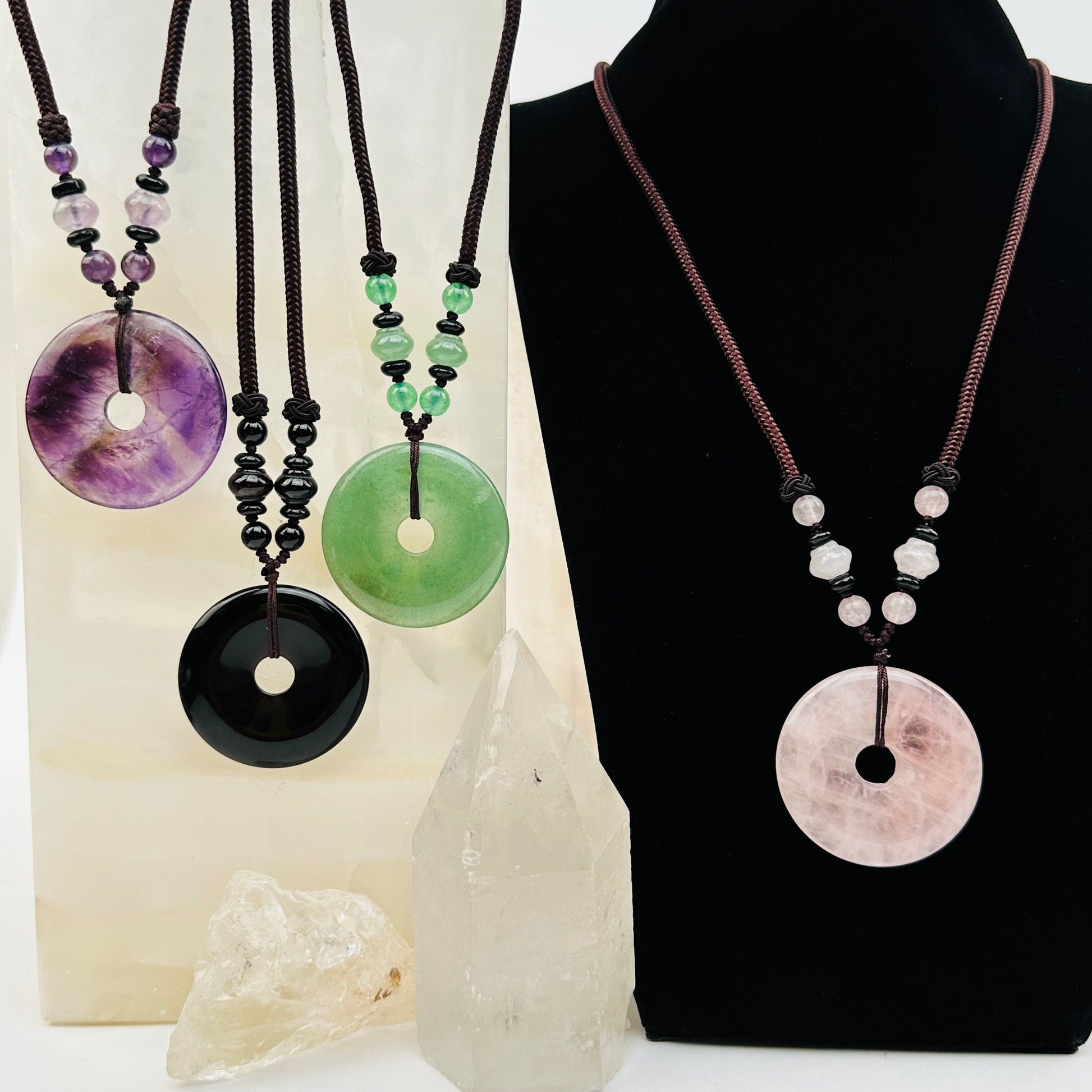 multiple necklaces displayed to show the differences in the gemstone types