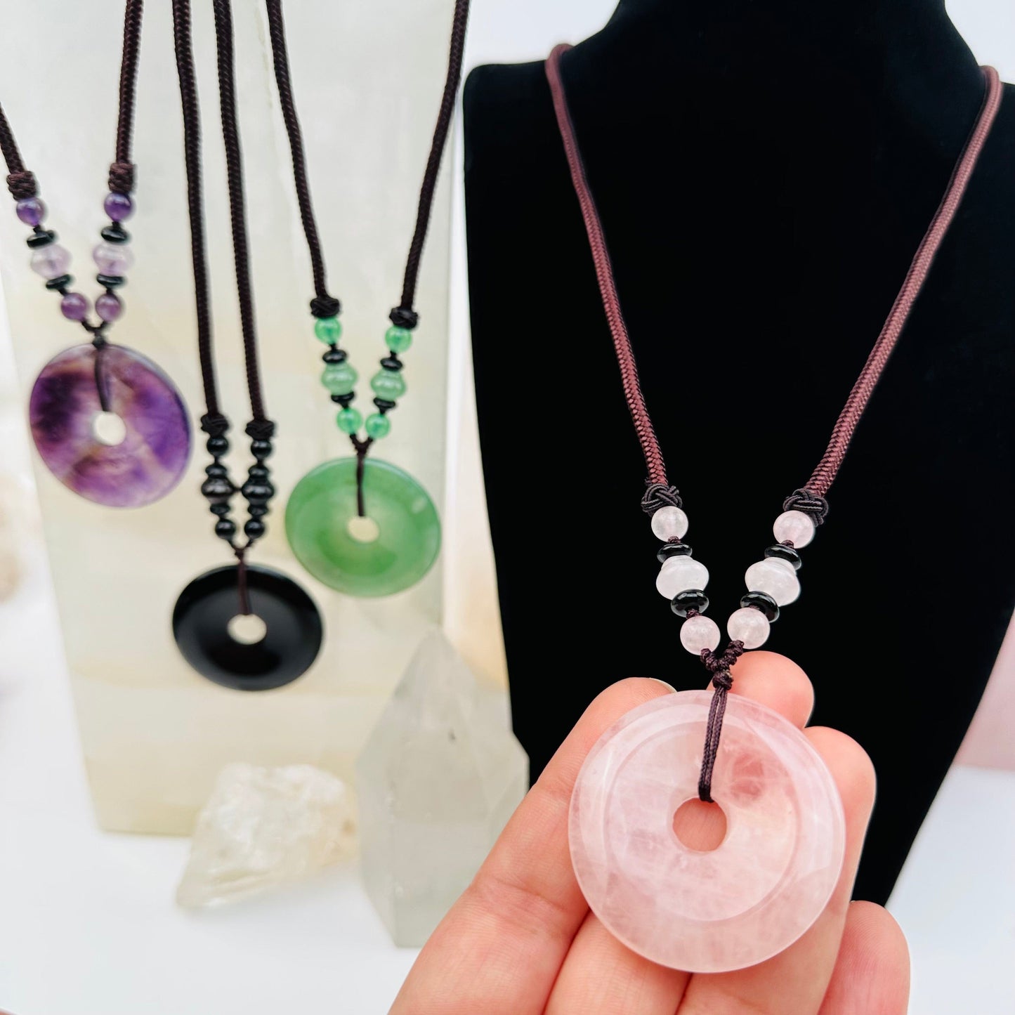 Round Disk Crystal Necklace in hand for size reference 