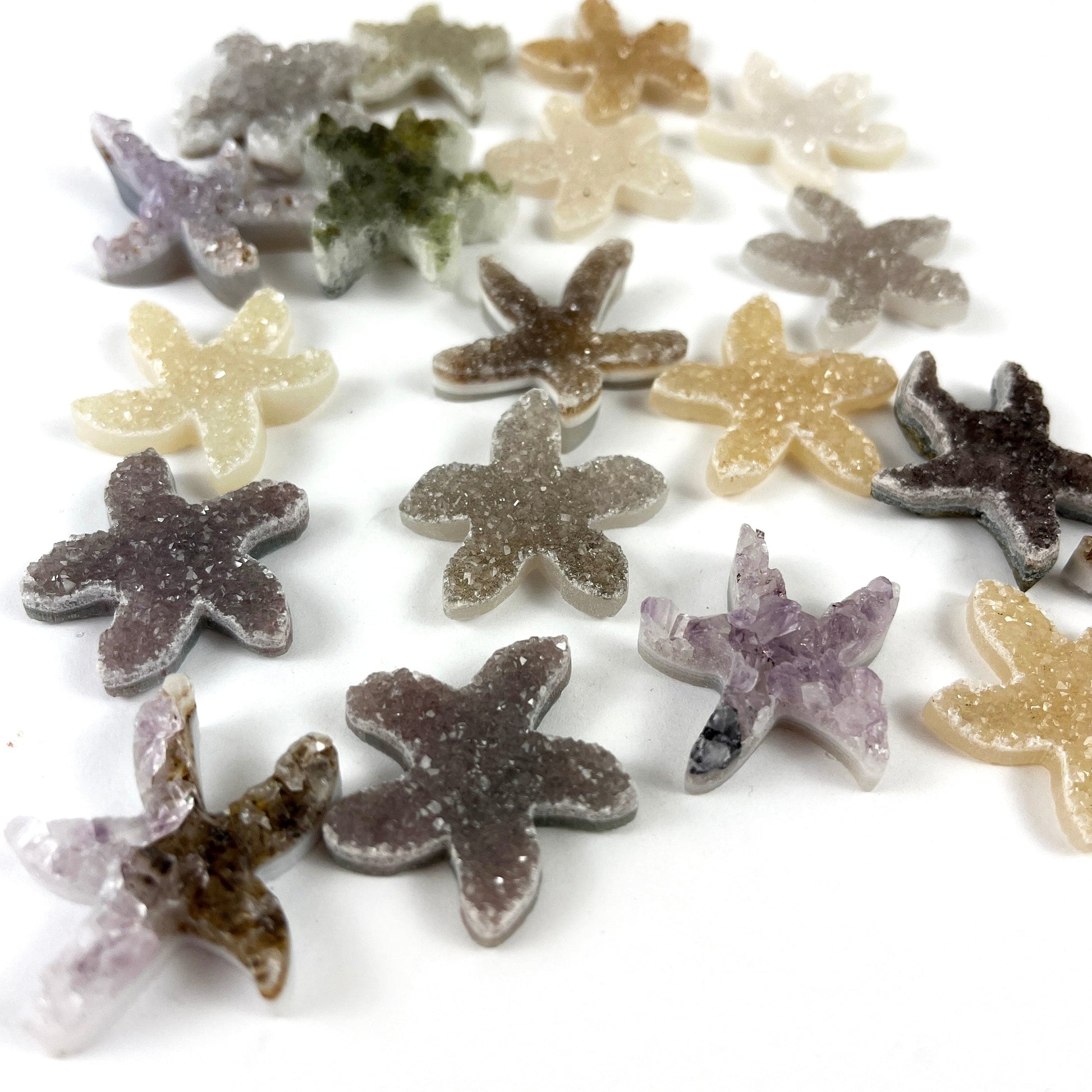 assortment of Druzy 30mm Starfish Shaped Cabochons from a side view
