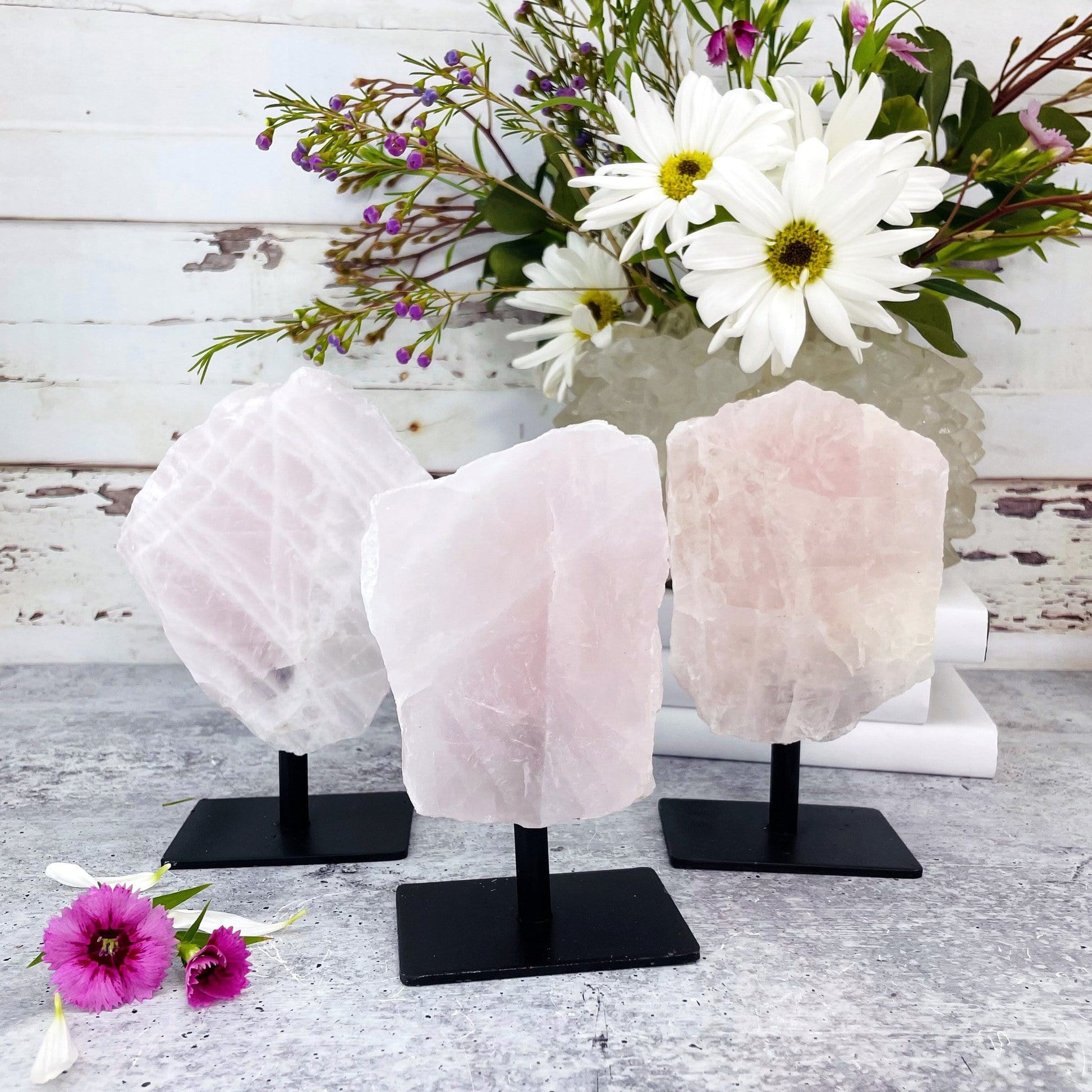 3 rose quartz chunks on a metal stand