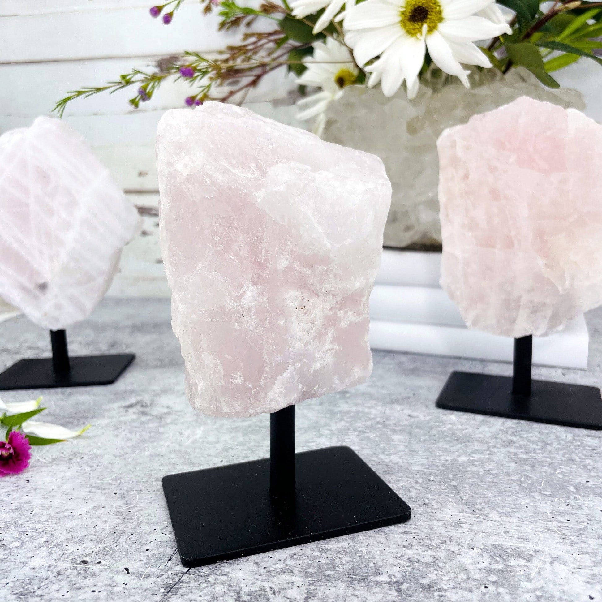 close up of rose quartz on a metal stand