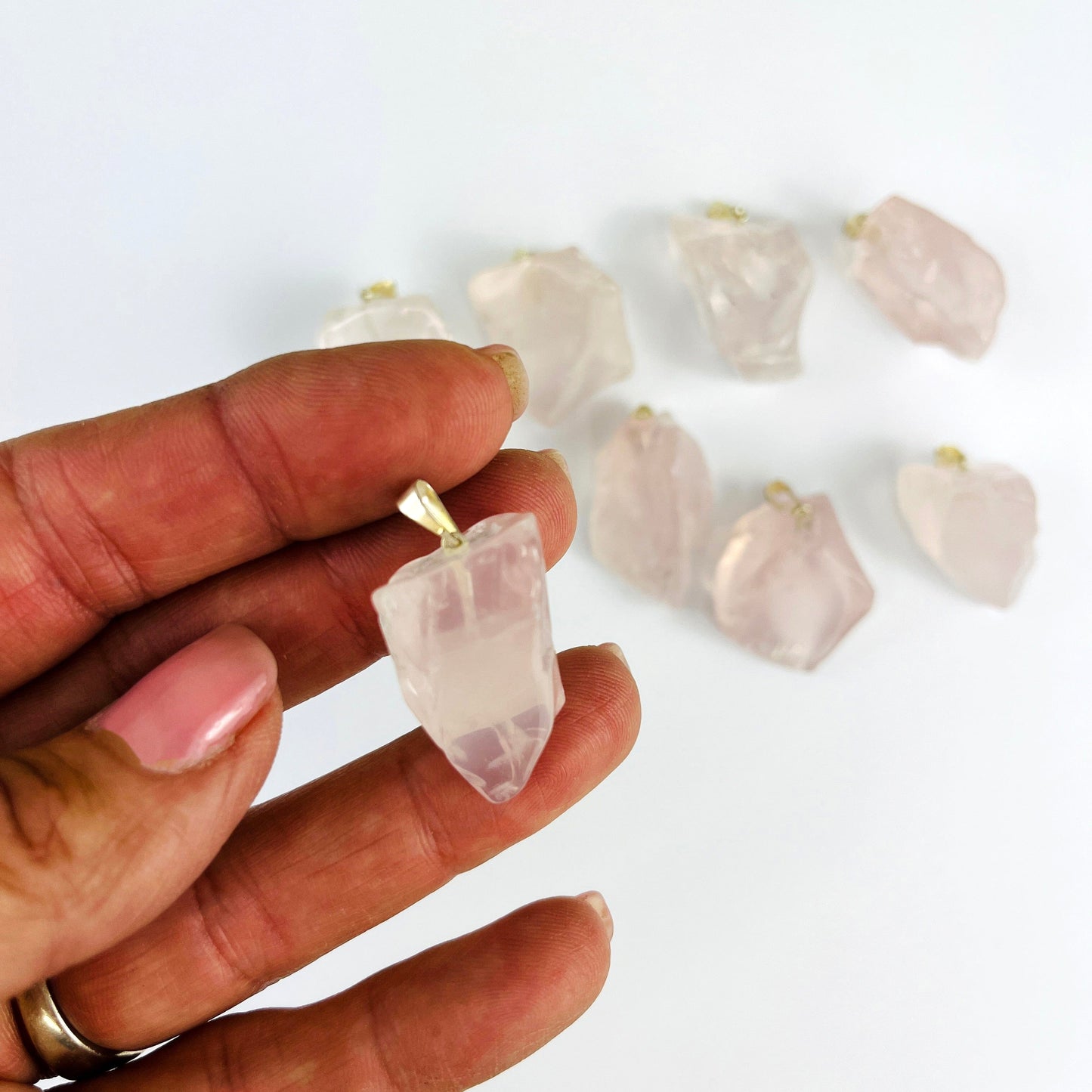 Crystal Rose Quartz Polished Free Form Pendant with Silver Bail with 1  in a hand for reference