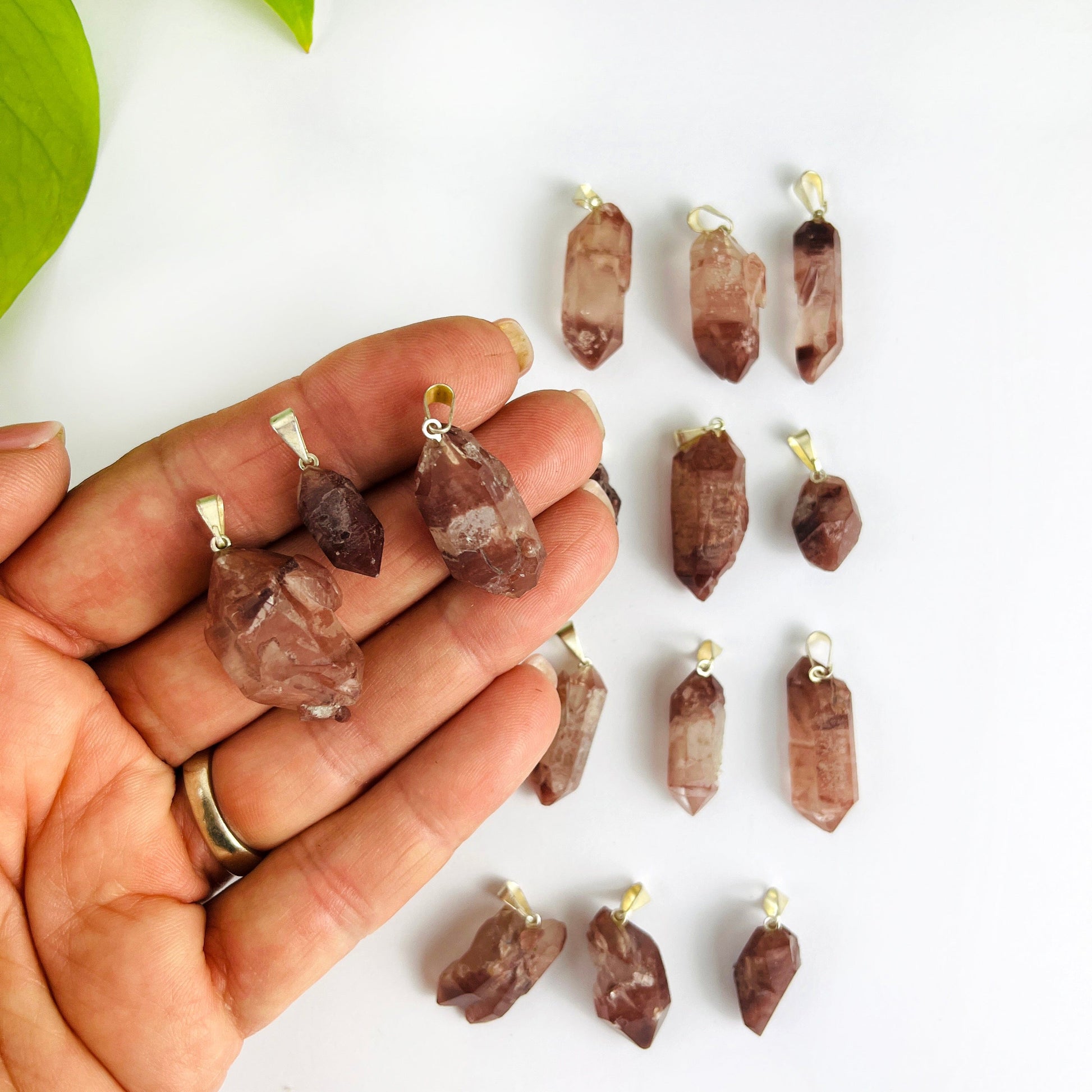Lithium Crystal Point Pendants with Silver Bail with 3 in a hand showing variations